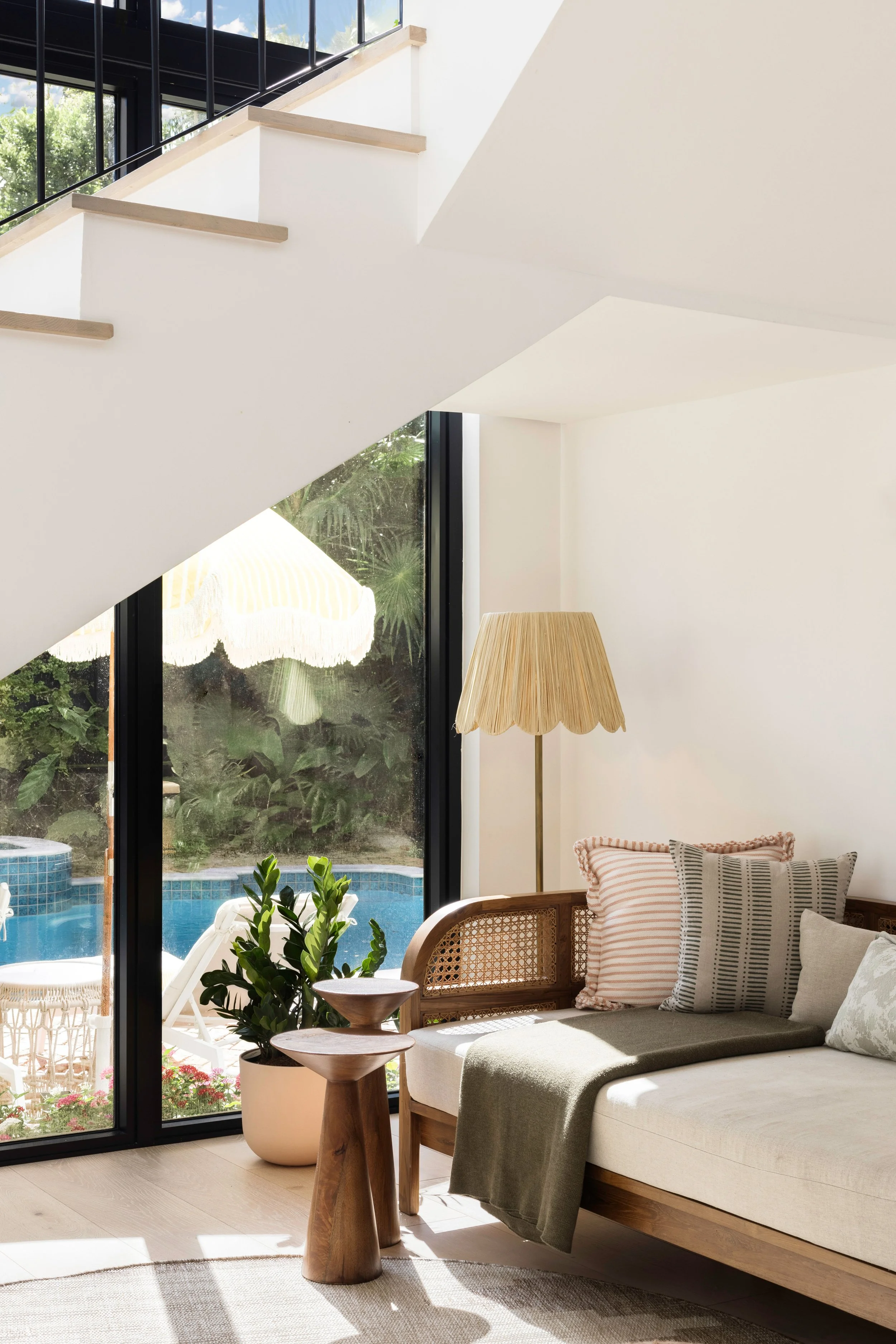 Stairway space with lounger underneath overlooking the outdoor pool area - Coastal Boho Estate - Coconut Grove - CURATED. Studio