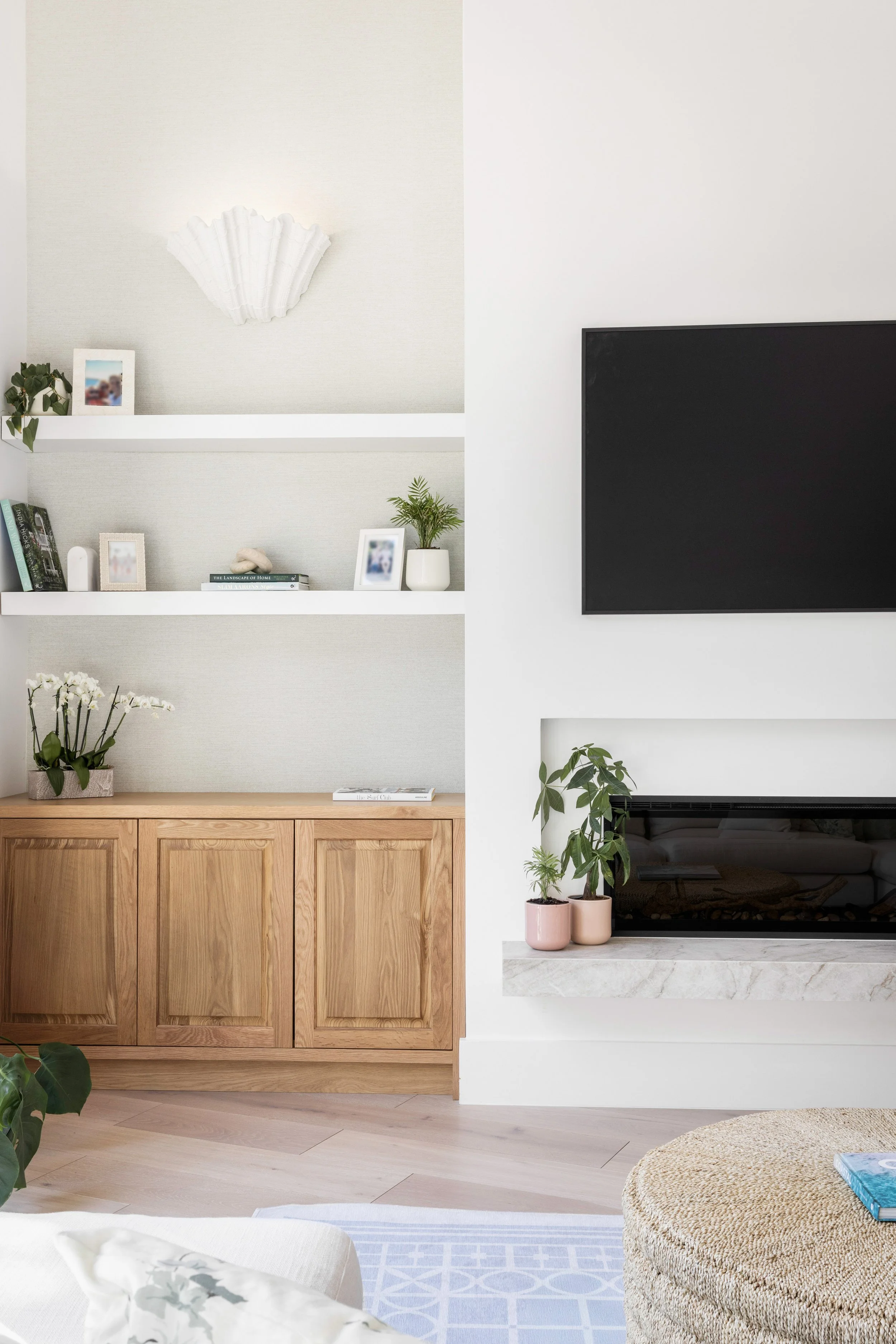 Close up shot of a fireplace with warm wood cabinets - Coastal Boho Estate - Coconut Grove - CURATED. Studio