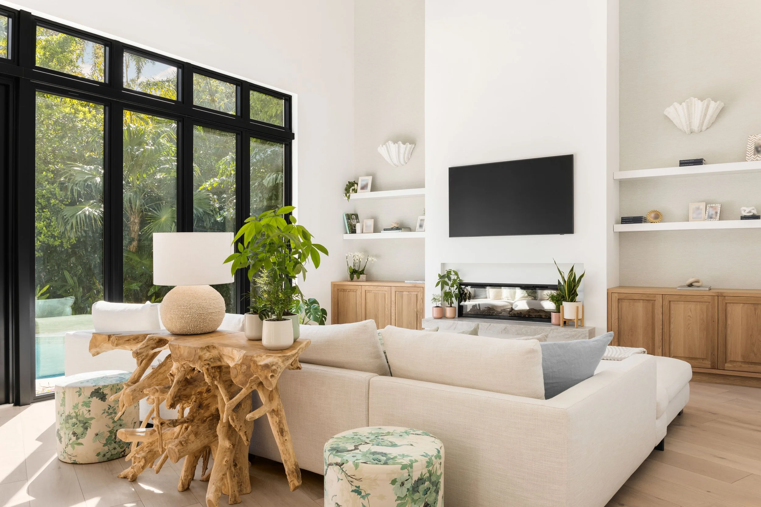 Warm accents and a beige sofa in a family room - Coastal Boho Estate - Coconut Grove - CURATED. Studio