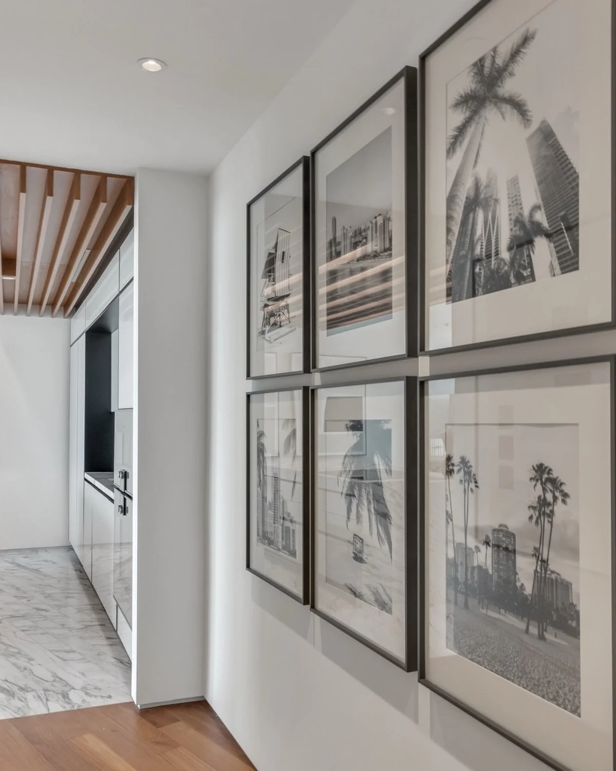 Who said hallways need to be boring?

For this vacation home at Monad Terrace, we curated a gallery wall featuring black-and-white Miami Beach motifs. 

The result is understated and cohesive, adding a sophisticated touch to this pied-dans-l&rsquo;ea