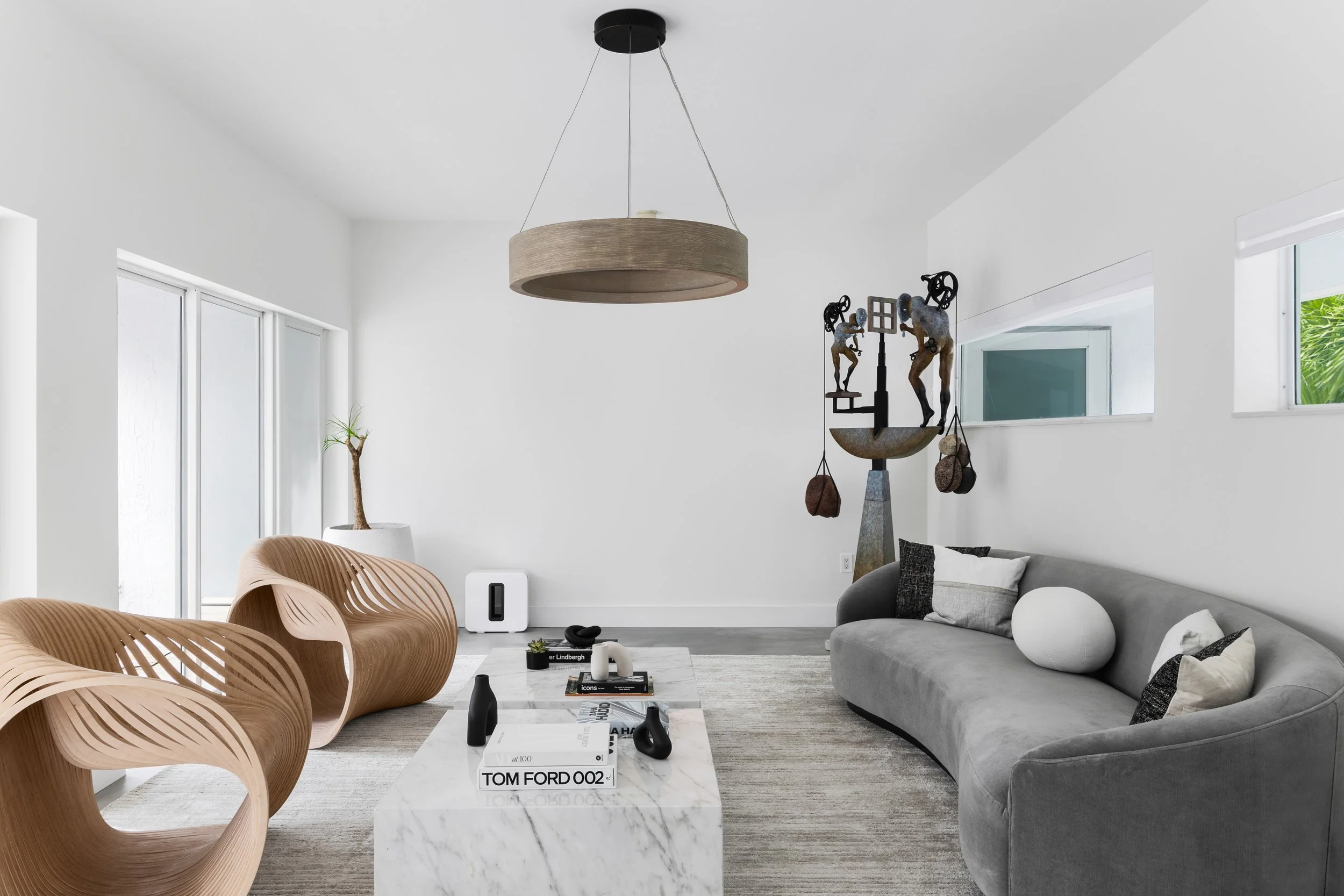 Living room with sculptural accent chairs - Modernized Brutalist Architecture - Coconut Grove - CURATED. Studio