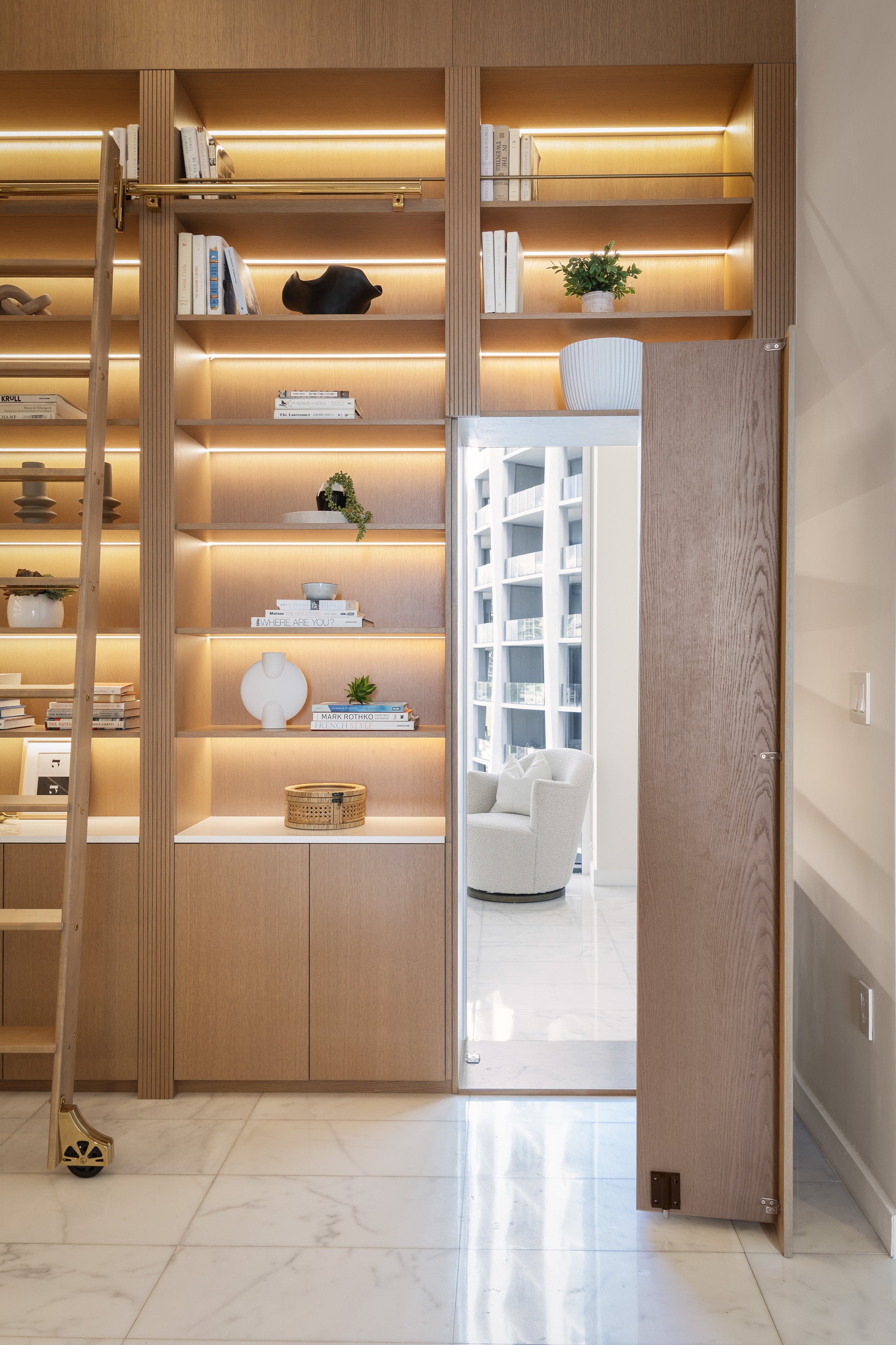 Hidden doorway built into a custom bookshelf - Two Park Grove - Parisian Inspired Design - CURATED. Studio