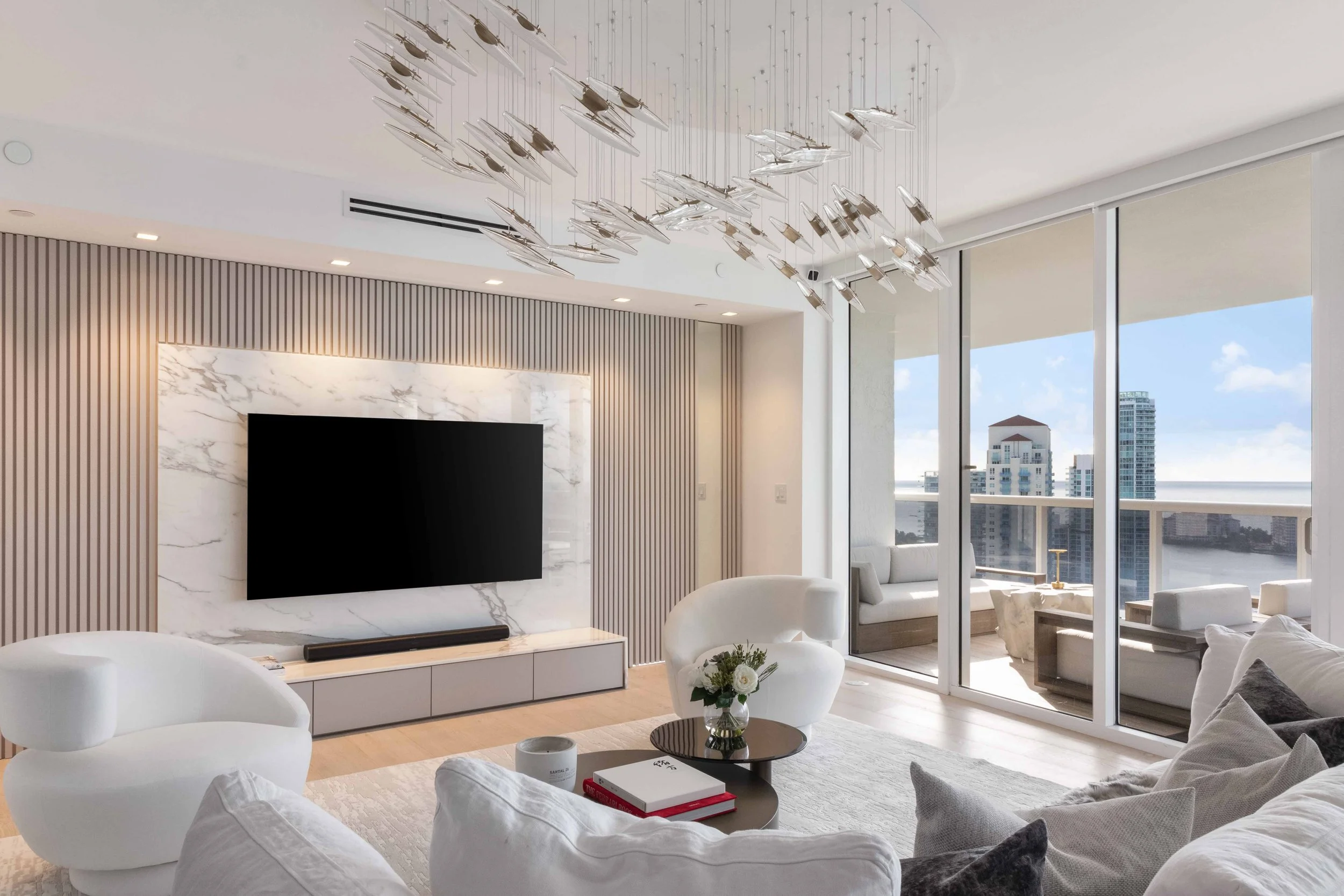 Modern living room with hidden doorway - Murano Grande - South of Fifth Design - CURATED. Studio