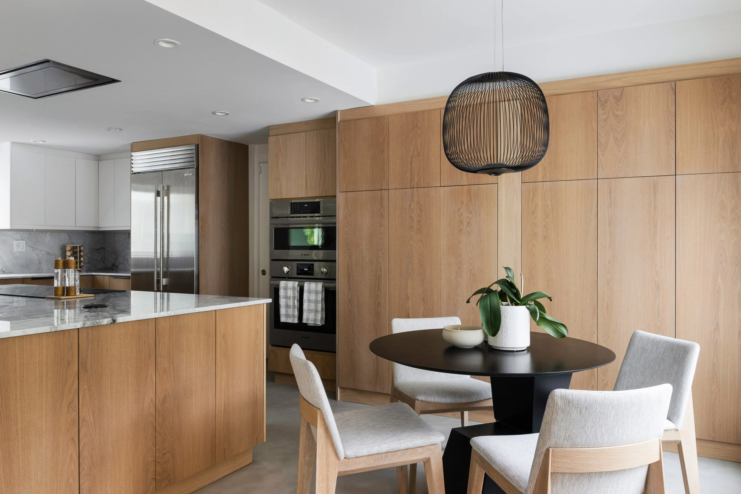 Dining room overlooking kitchen - Modernized Brutalist Architecture - Coconut Grove - CURATED. Studio