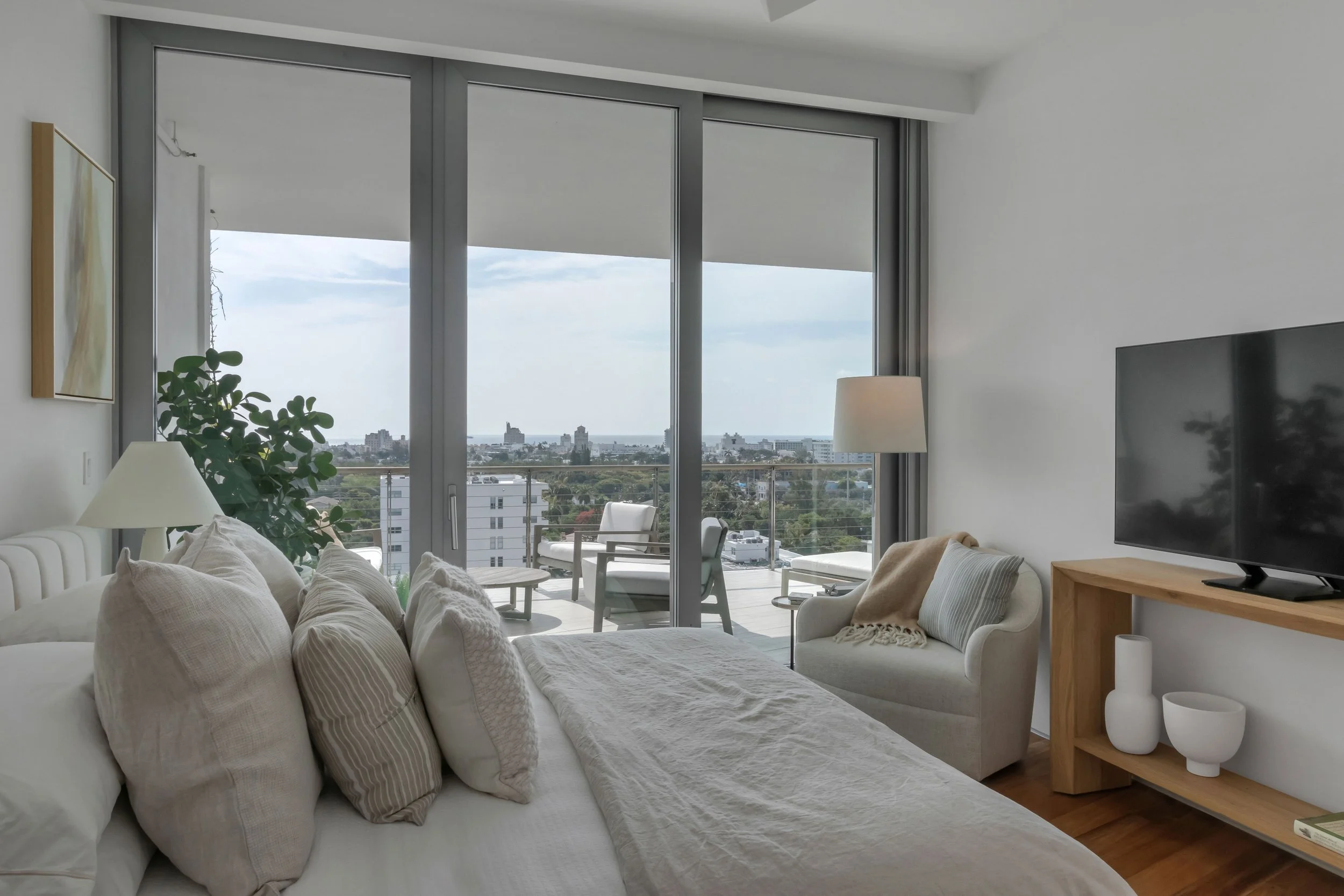 Contemporary bedroom with expansive balcony - Monad Terrace - "New Miami" Coastal Design - CURATED. Studio