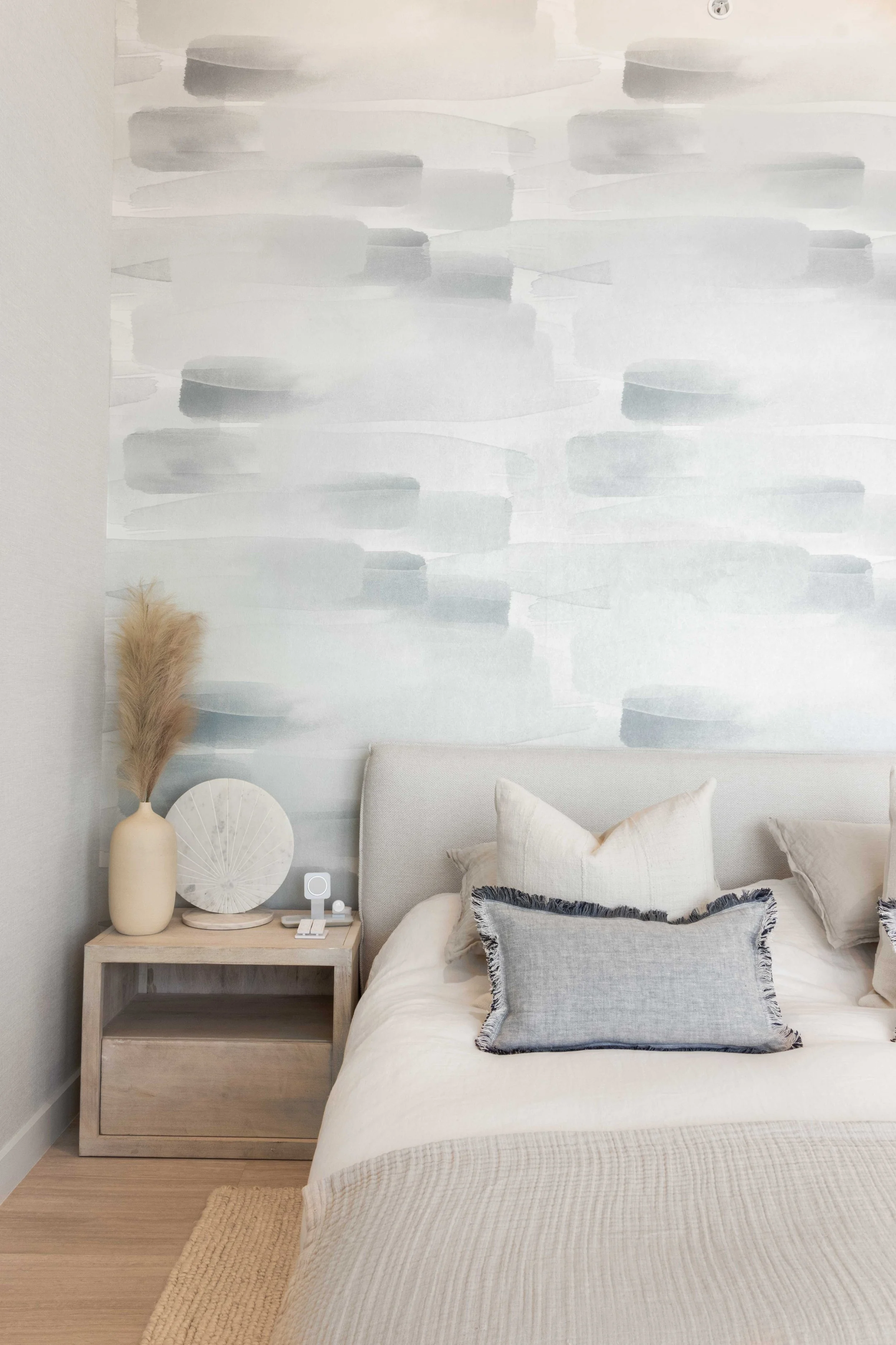 Cozy bedroom with accent wallpaper- Park Grove Condo - Coastal Contemporary Design - CURATED. Studio