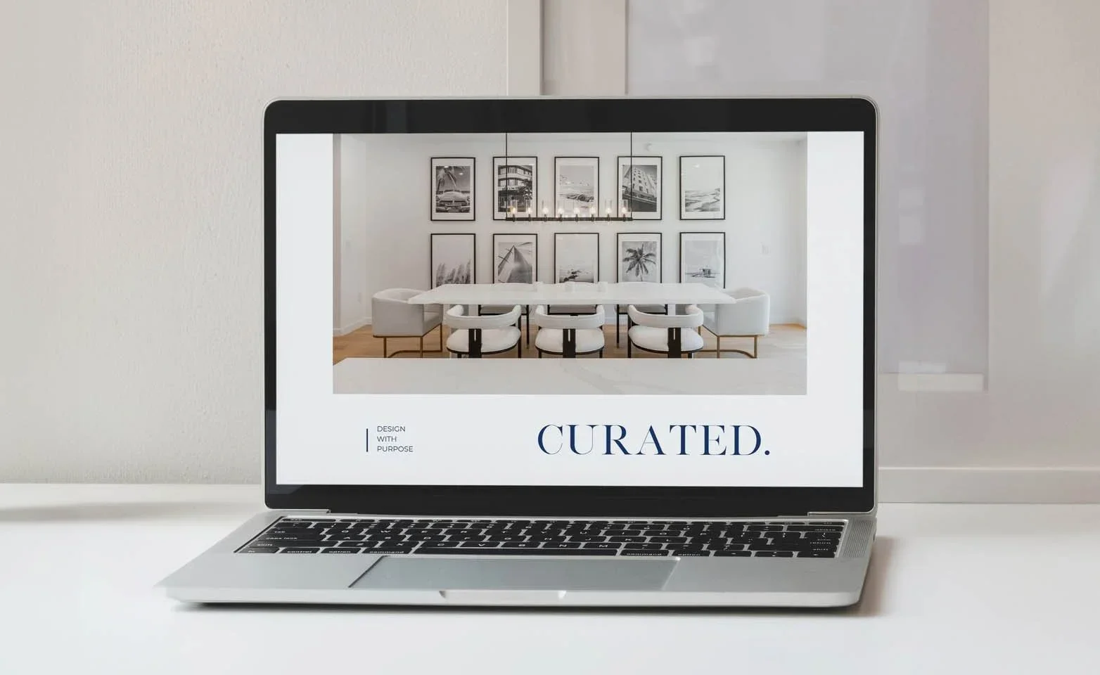 Laptop looking at the website of CURATED. Studio