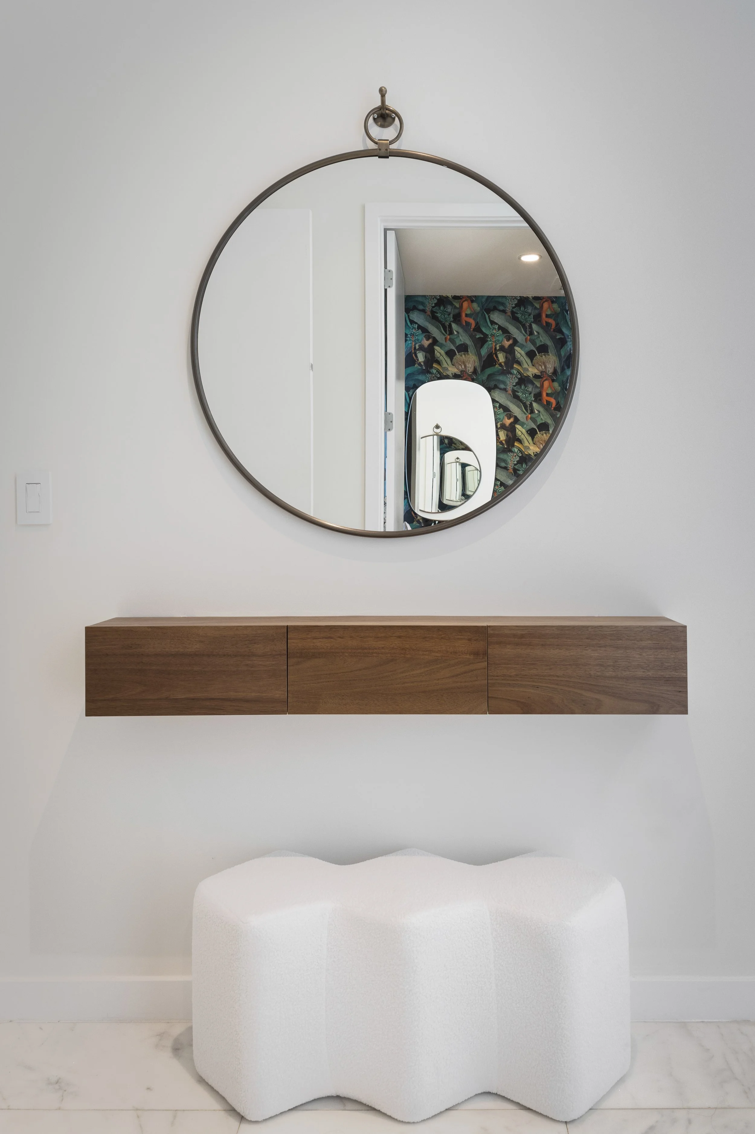 Detail shot of entryway with pouf and storage - Two Park Grove - Parisian Inspired Design - CURATED. Studio