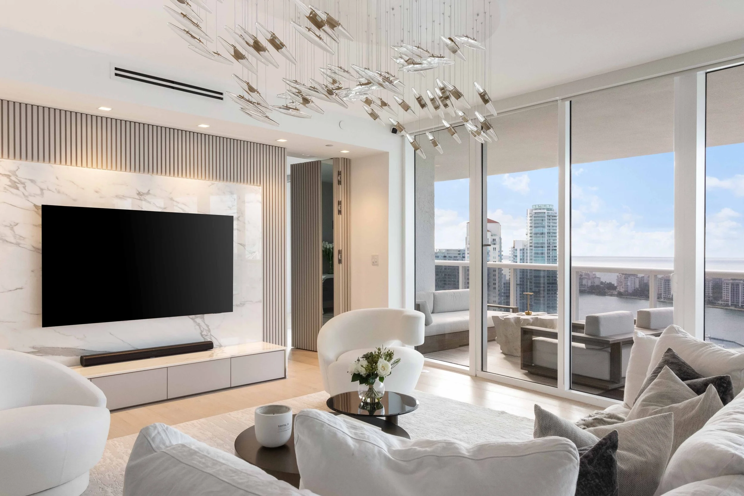 Modern living room with hidden doorway - Murano Grande - South of Fifth Design - CURATED. Studio