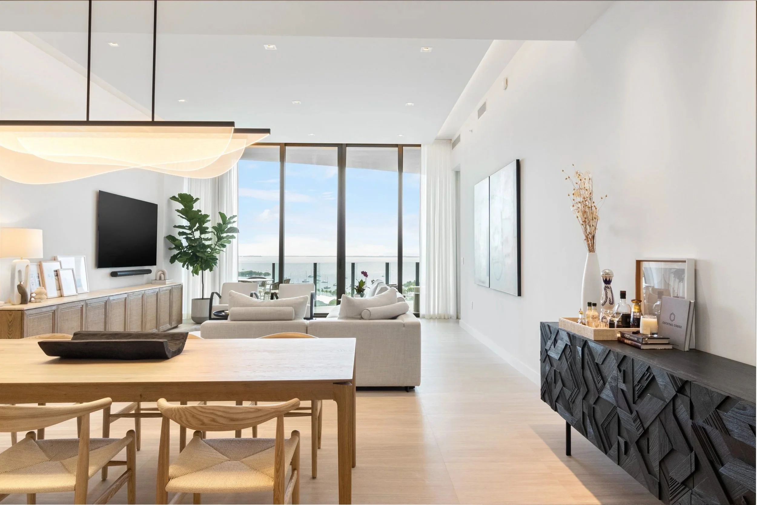 Dining space overlooking the living room - Park Grove Condo - Coastal Contemporary Design - CURATED. Studio