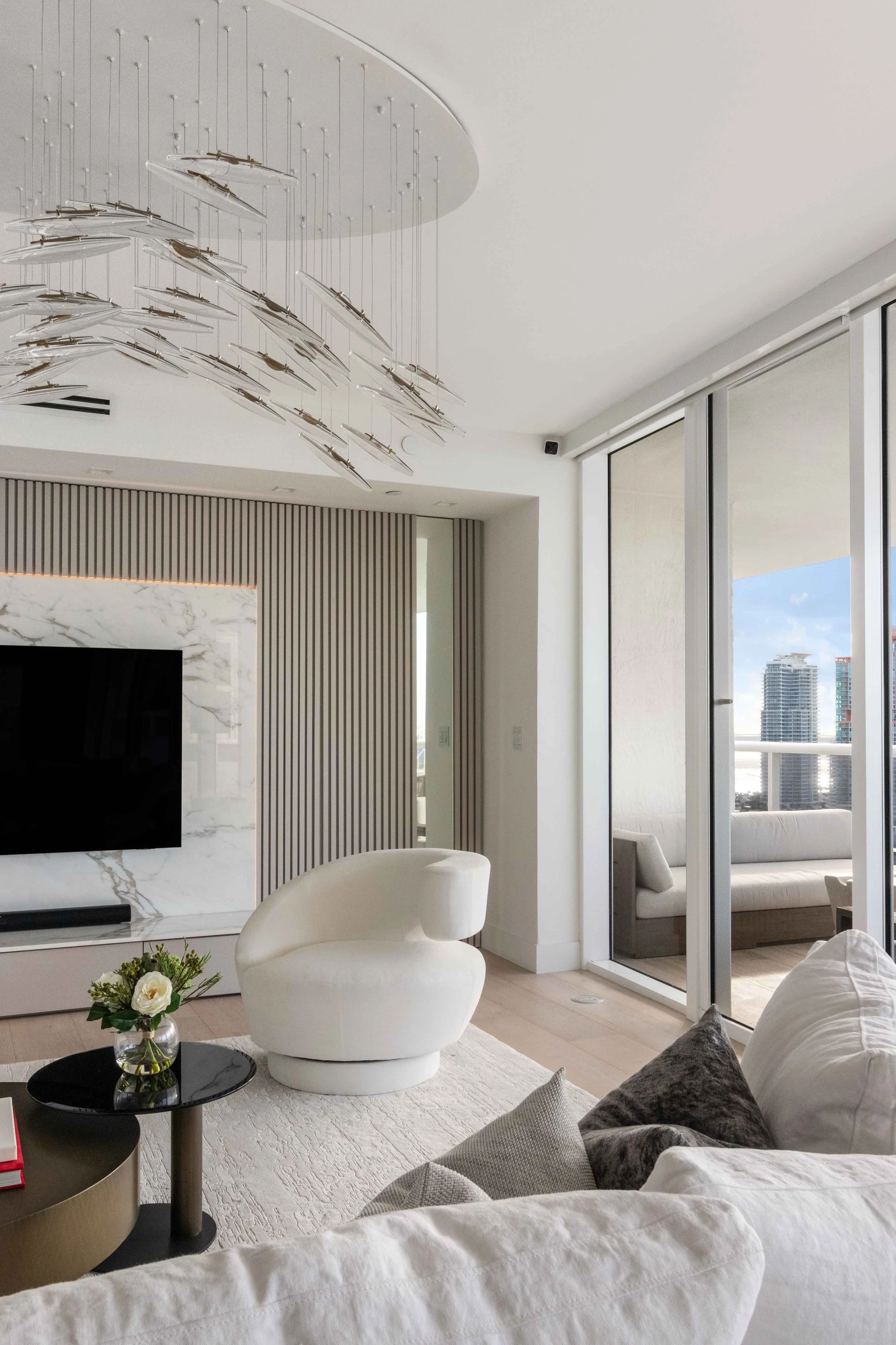 Modern living room with hidden doorway - Murano Grande - South of Fifth Design - CURATED. Studio