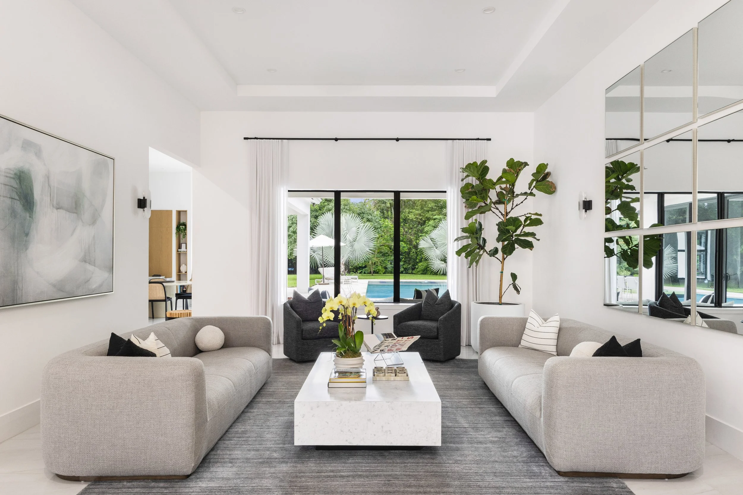 Living room overlooking backyard with swimming pool - Modern Family Estate - Pinecrest - CURATED. Studio