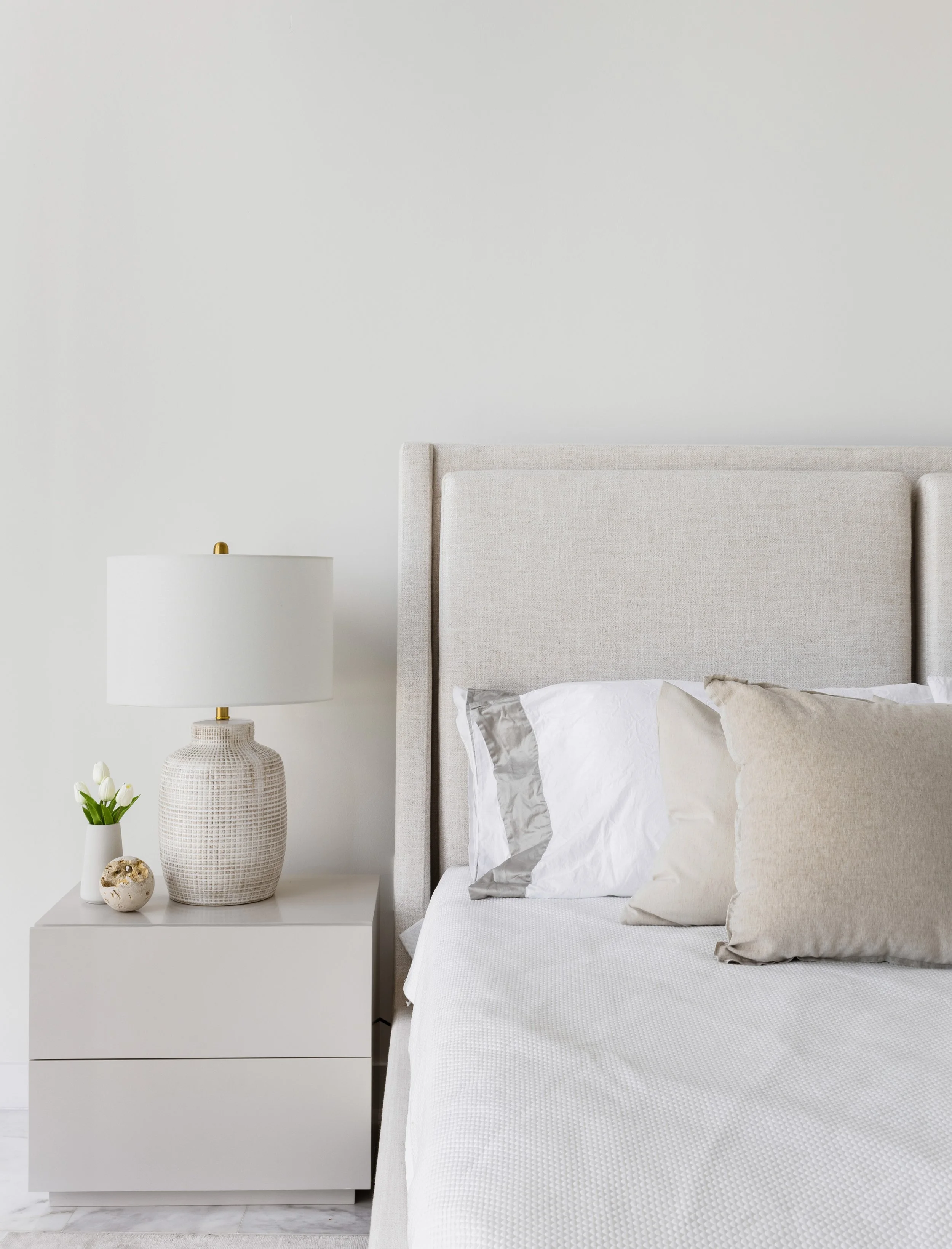 Detail shot of upholstered bed plus nightstand - Parisian Inspired Design - CURATED. Studio