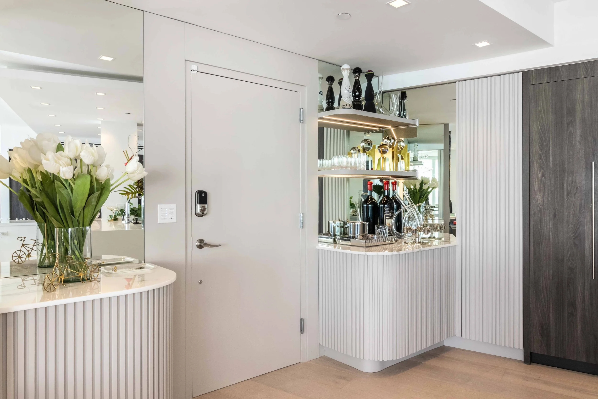 Modern entry with bar feature - Murano Grande - South of Fifth Design - CURATED. Studio