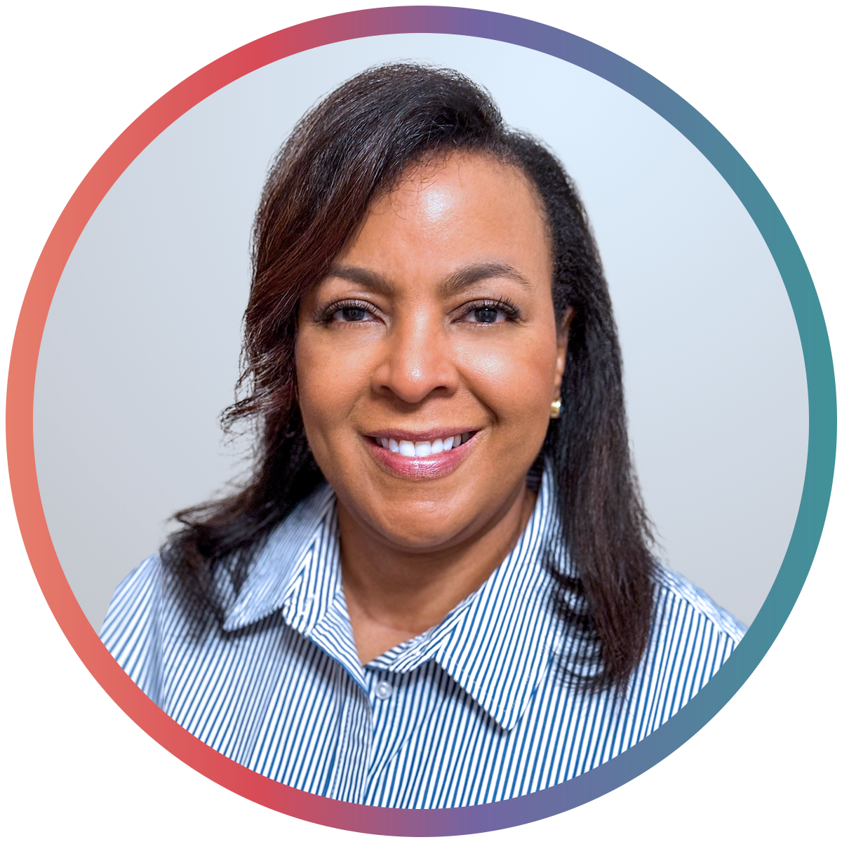 Headshot of a smiling woman with dark hair, wearing a striped collared shirt against a light gray background.