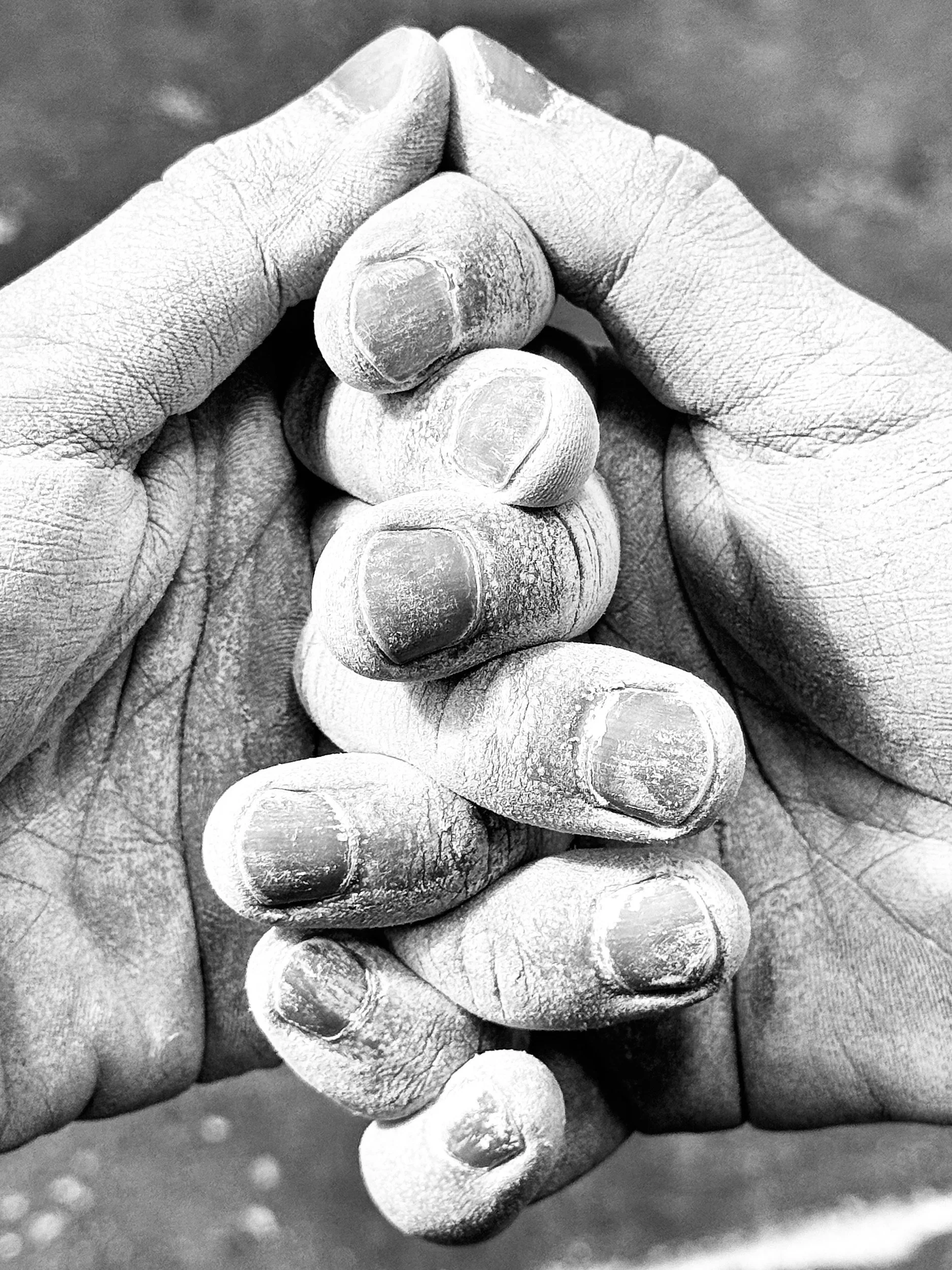 chalked climbing fingers intertwined
