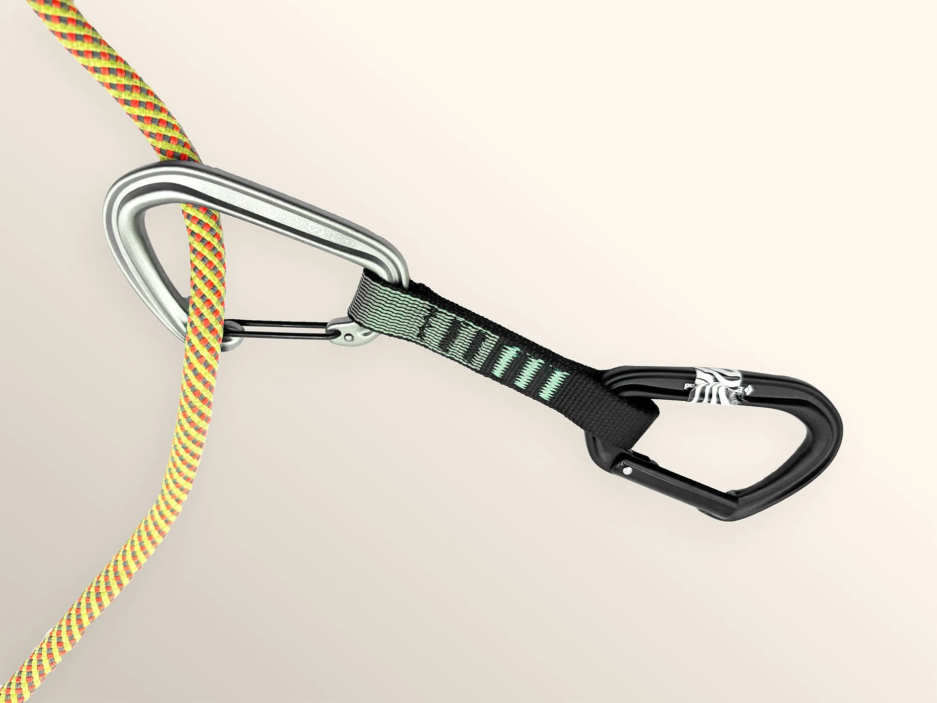 Climbing gear with a colorful rope, a safety strap, and two carabiners connected to a metal anchor point.