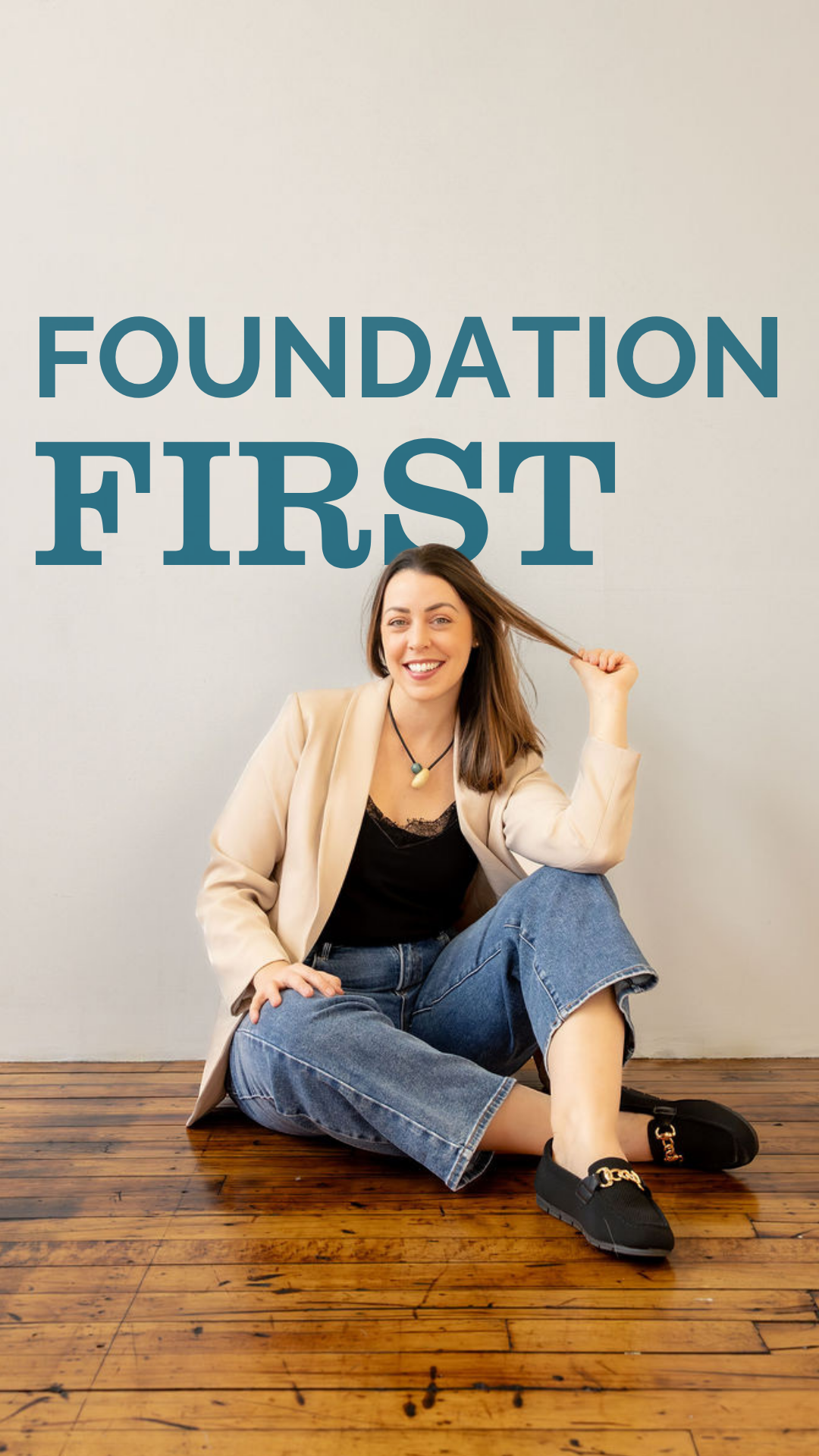 Kelly Martins Founder of GRATI Consulting sitting on the floor in front of text that reads Foundation First
