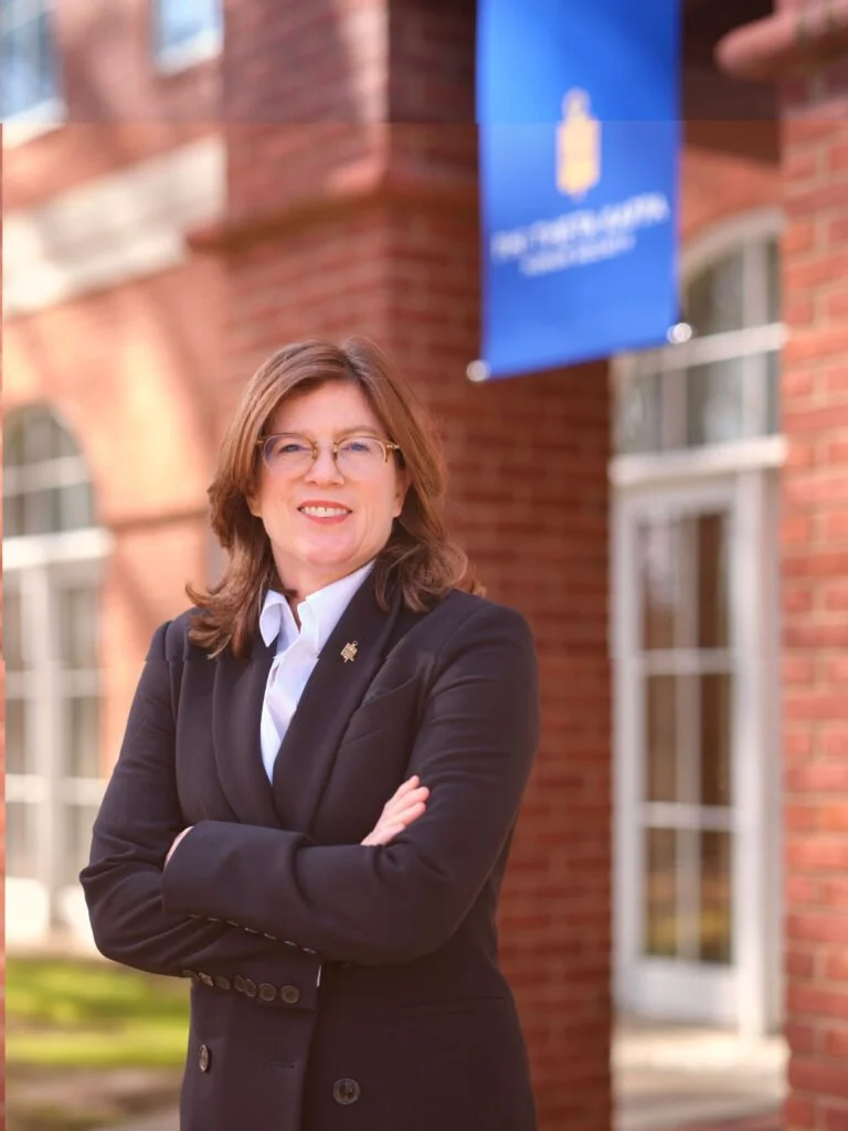 Dr. Lynn Tichner-Ladner smiling outside the PHI THETA KAPPA headquarters building