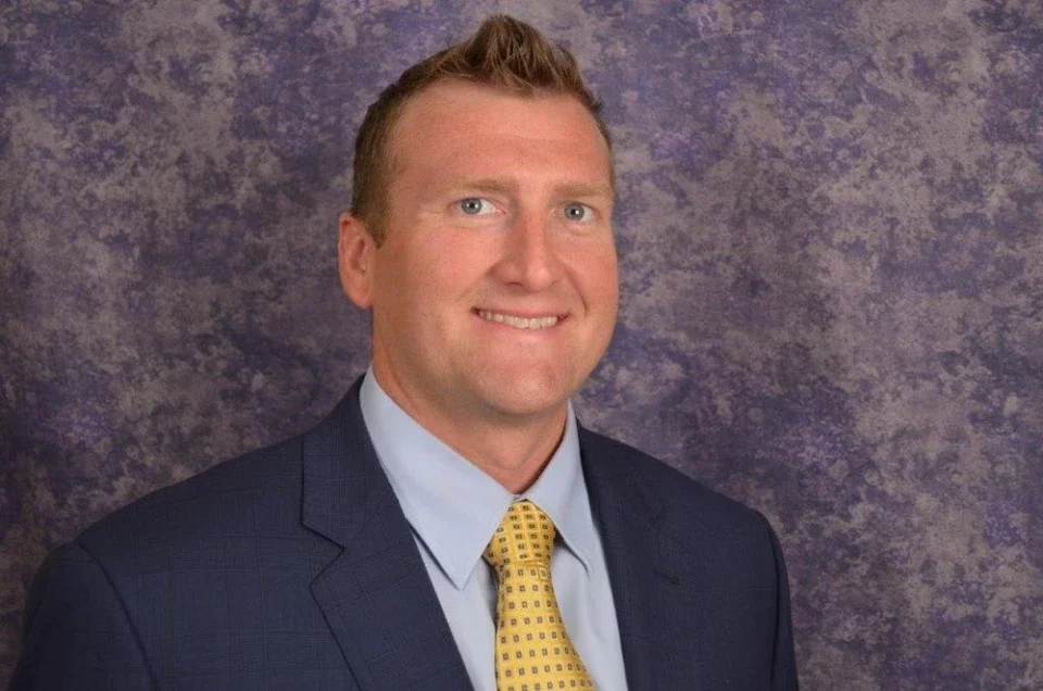 Cody Waits smiling in a professional headshot