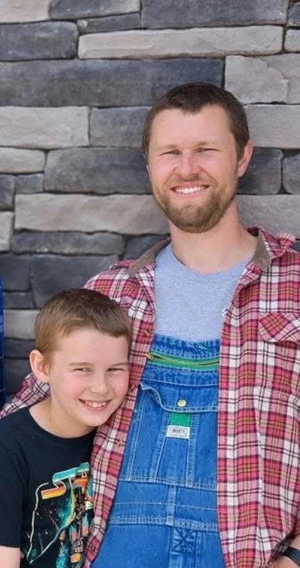 A man with dark hair and his son.
