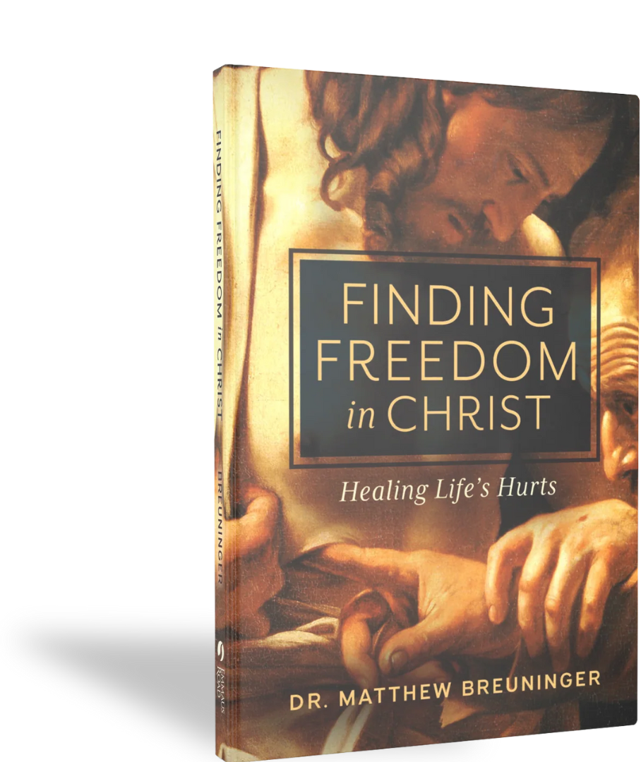 Book titled "Finding Freedom in Christ", with a cover image depicting a close-up of Jesus Christ's face and hands, illustrating a moment of prayer or reflection.  | Dr Matthew Breuninger | Therapist, Catholic Speaker, Course Creator, and Author | Ste
