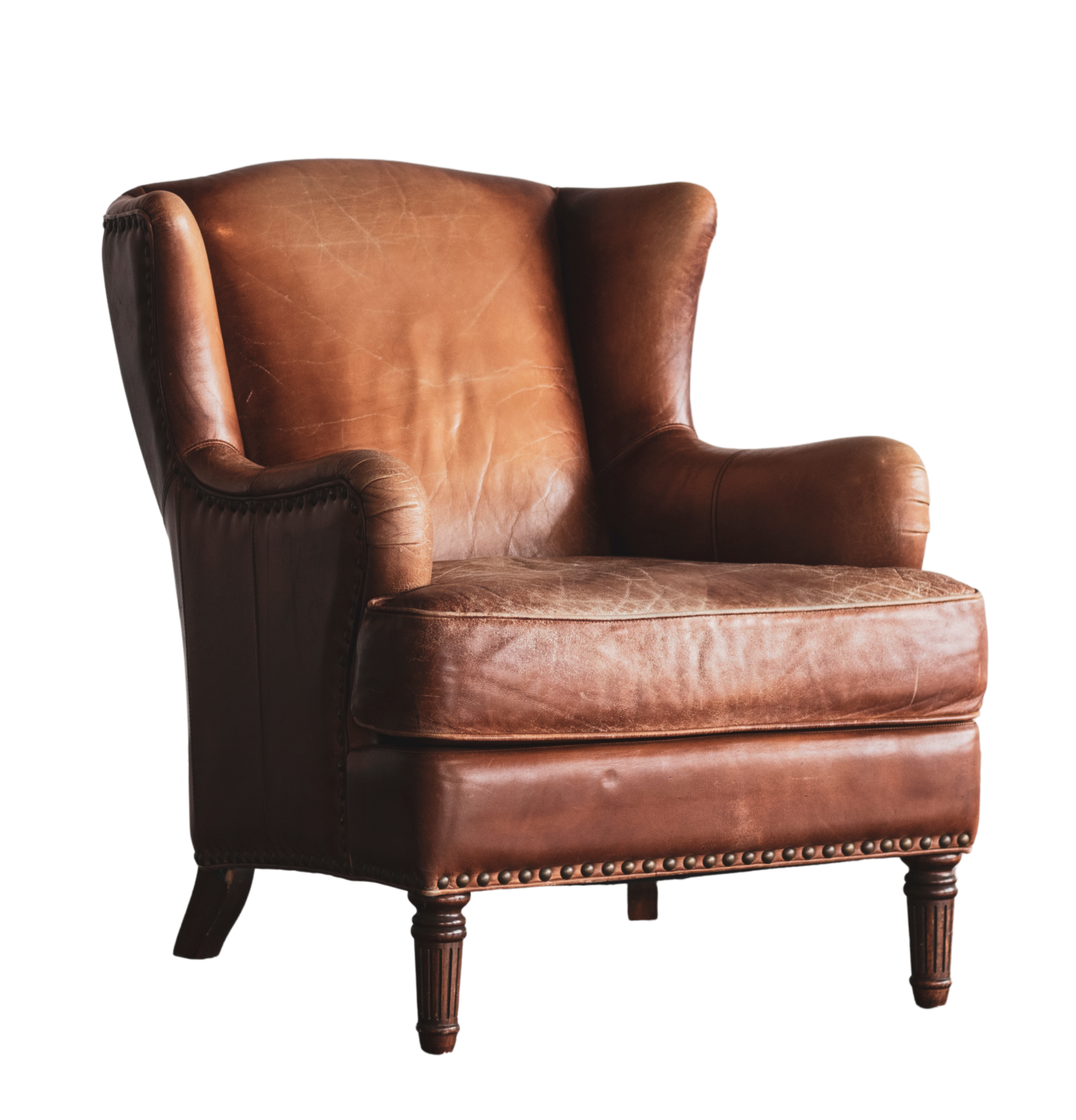 A vintage brown leather wingback armchair with wooden legs and nailhead trim  | Dr Matthew Breuninger | Therapist, Catholic Speaker, Course Creator, and Author | Steubenville, OH