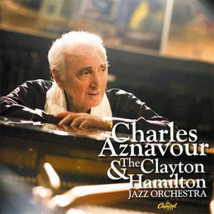 Album cover of Charles Aznavour & The Clayton Hamilton Jazz Orchestra, featuring an elderly man with white hair resting his arms on a piano.