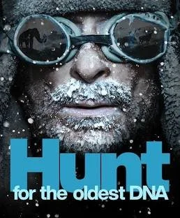 Close-up of a man wearing goggles with snow or ice on his face, with text 'Hunt for the oldest DNA'