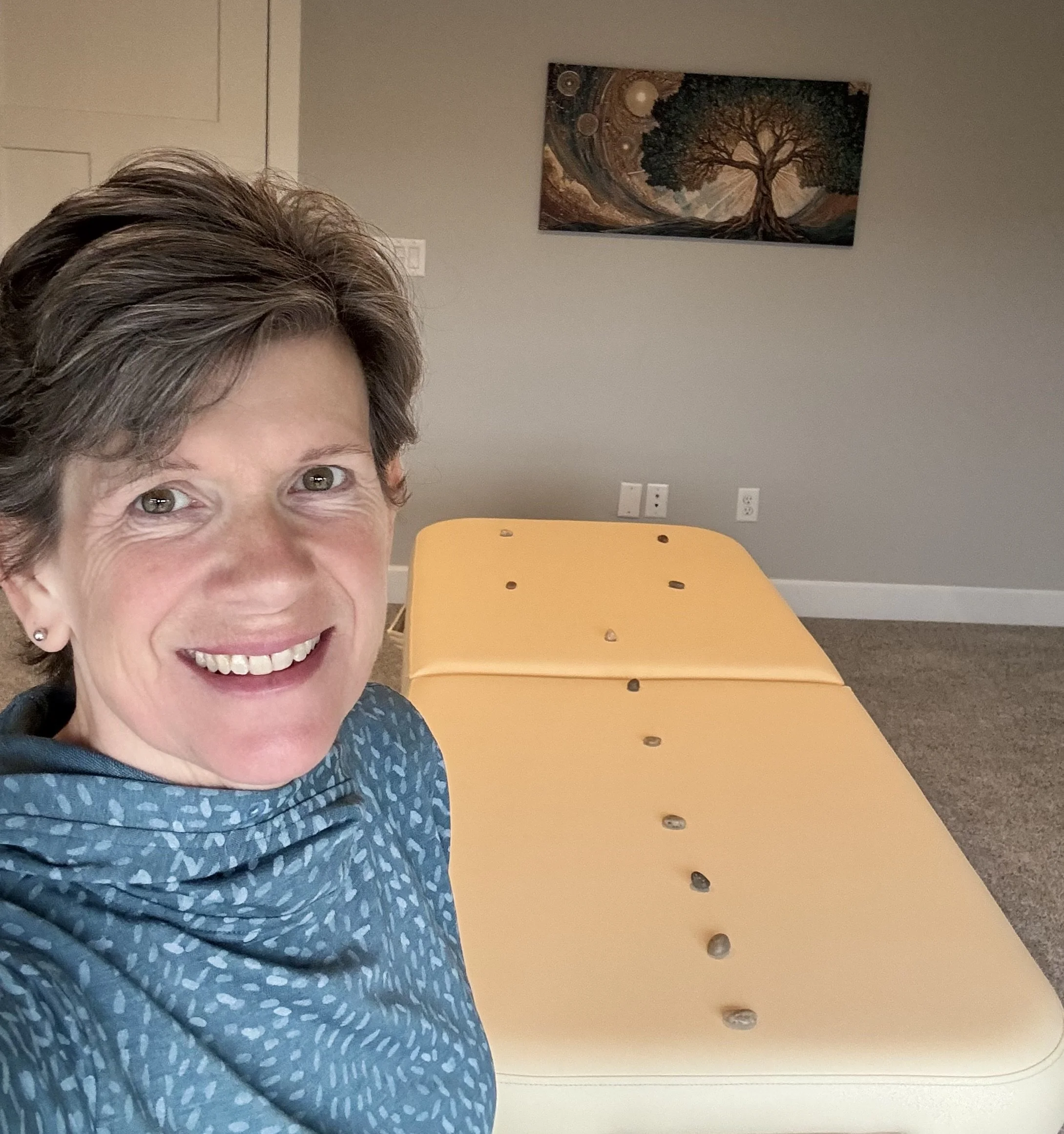 This is my home office, where I conduct healing sessions.  The massage table is set up with rocks, which represent different energy centers in the body when I work with people remotely.