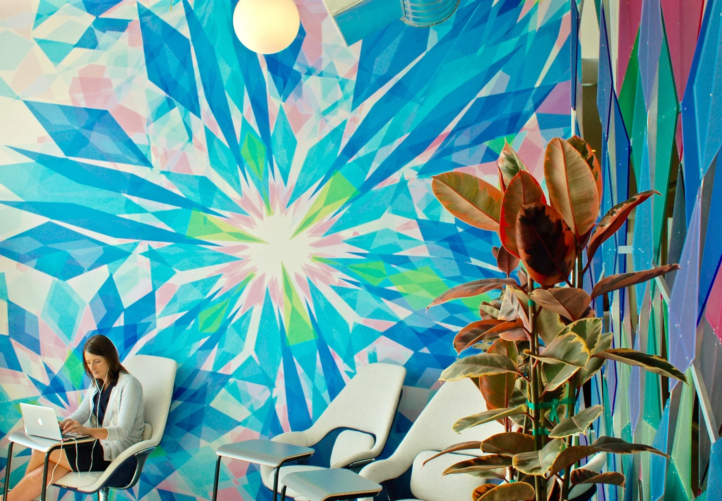 Abstract colorful mural wallcovering used to create a vibrant feature wall in a corporate or hospitality space.
