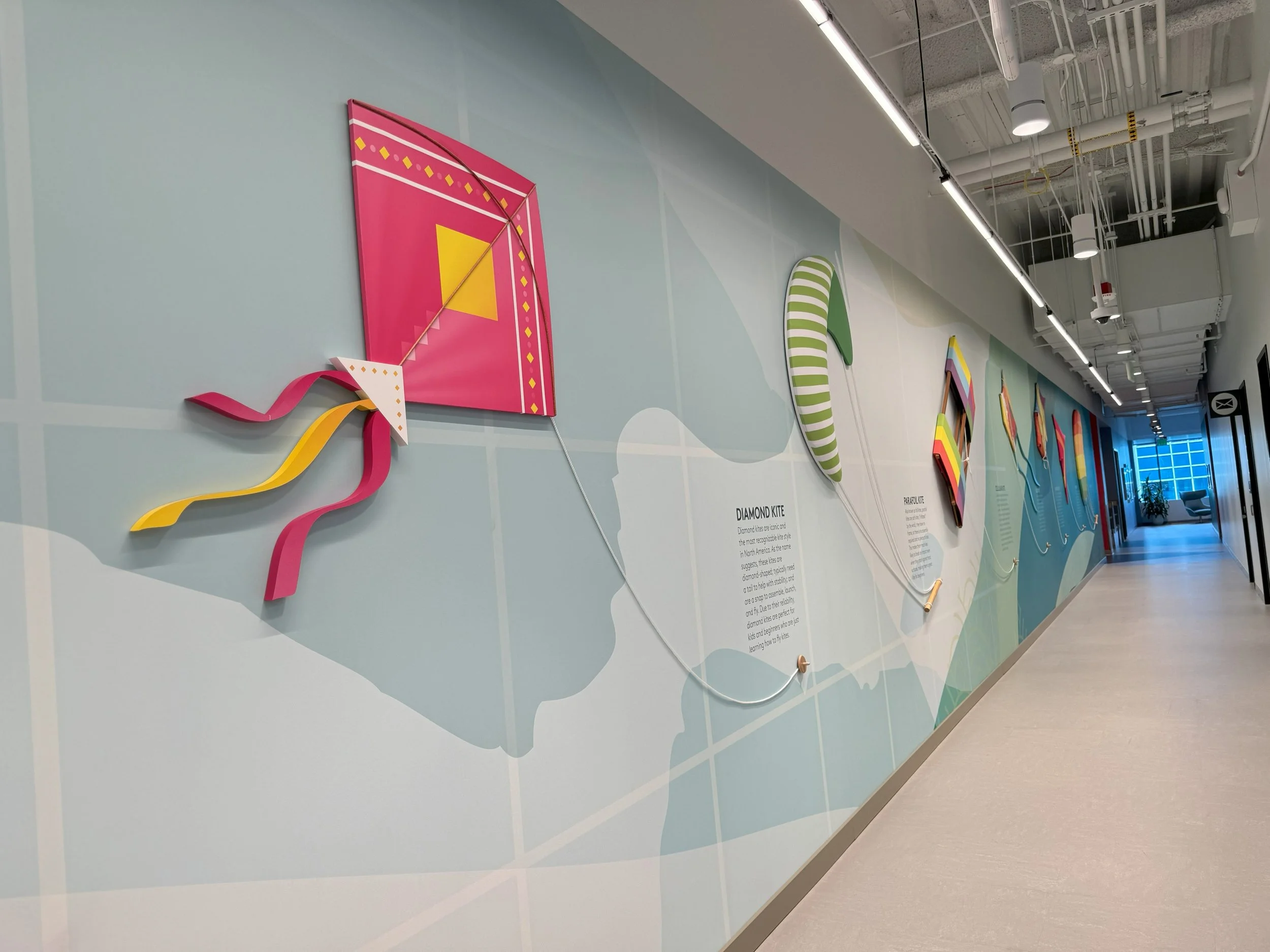 Custom environmental graphics and branded wall mural installed in office space to enhance workplace design and brand experience.