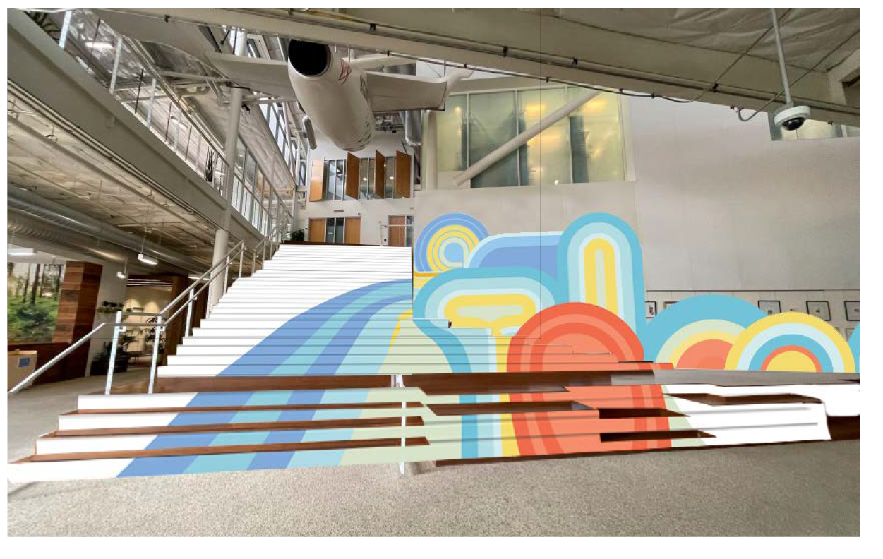 Completed custom environmental graphics installed along a commercial staircase with large-scale geometric wall and stair graphics in a modern office atrium