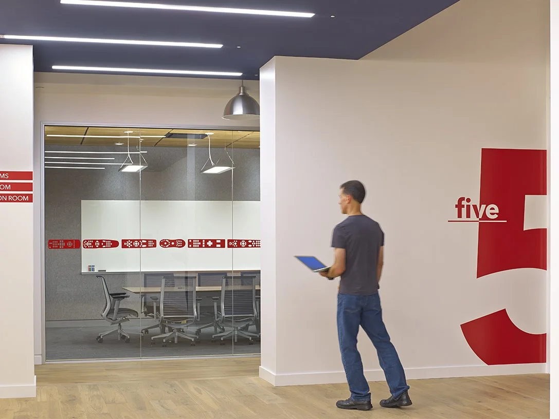 Custom privacy window film installation on curved interior glass wall in corporate environment