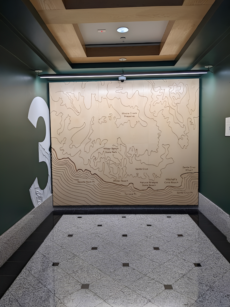 Third floor lobby feature at Google Santa Cruz with custom birch wood veneer dimensional elements creating a warm architectural branding installation.