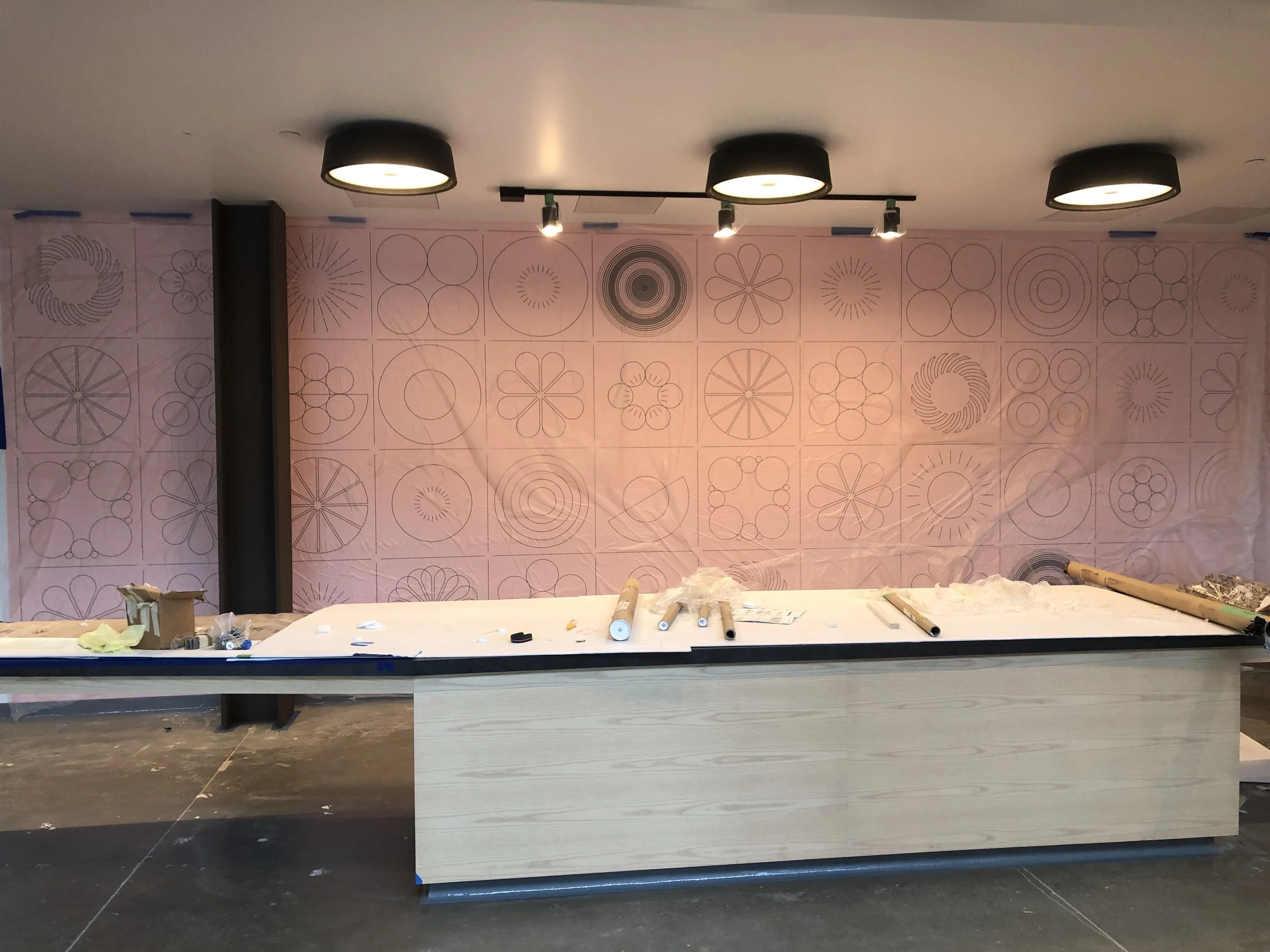 Custom wallcovering installation in progress showing panel alignment and preparation for large-scale commercial environmental graphics in the Humboldt project