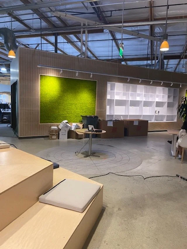 Custom wood feature walls and architectural elements in large open-plan commercial workspace