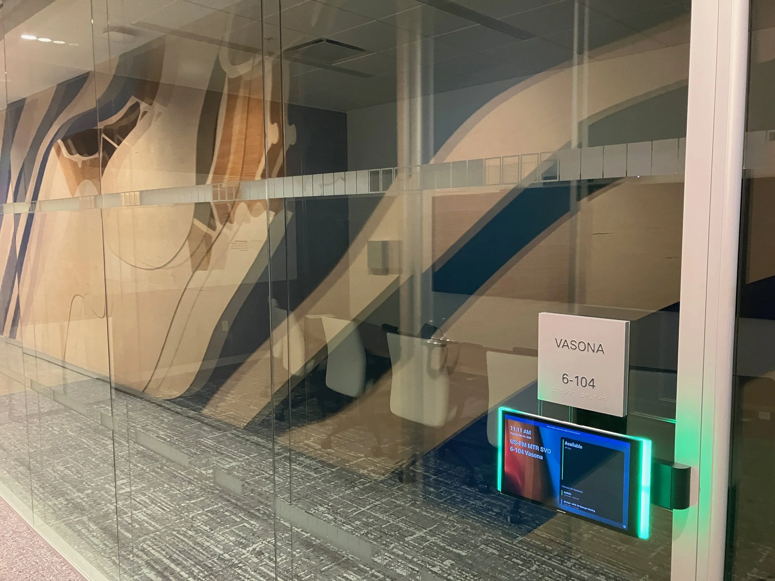 Glass office wall with distraction band window film and room identification signage installed at the KPMG San Jose office.