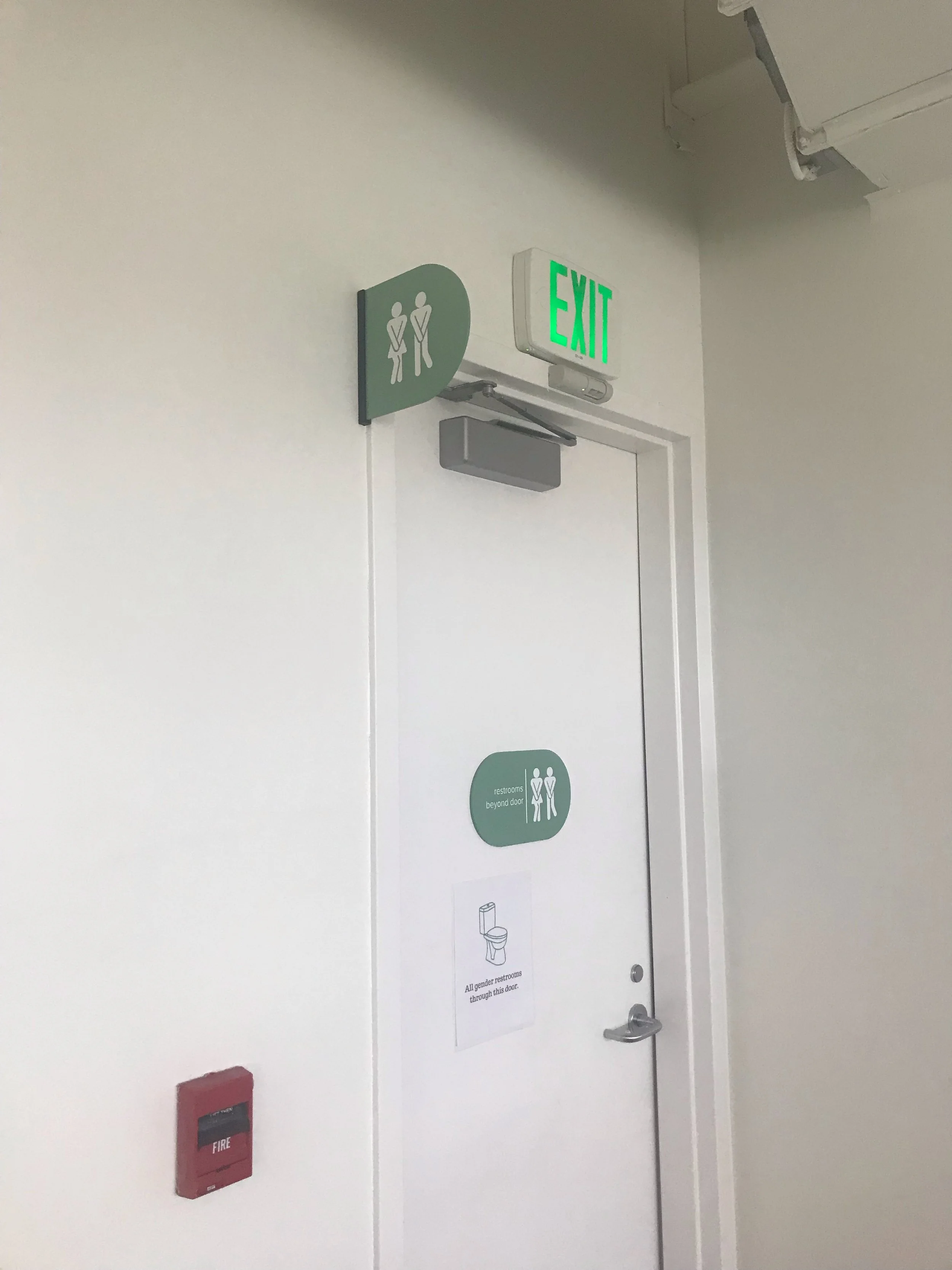 Interior bathroom signage designed to support wayfinding and building compliance