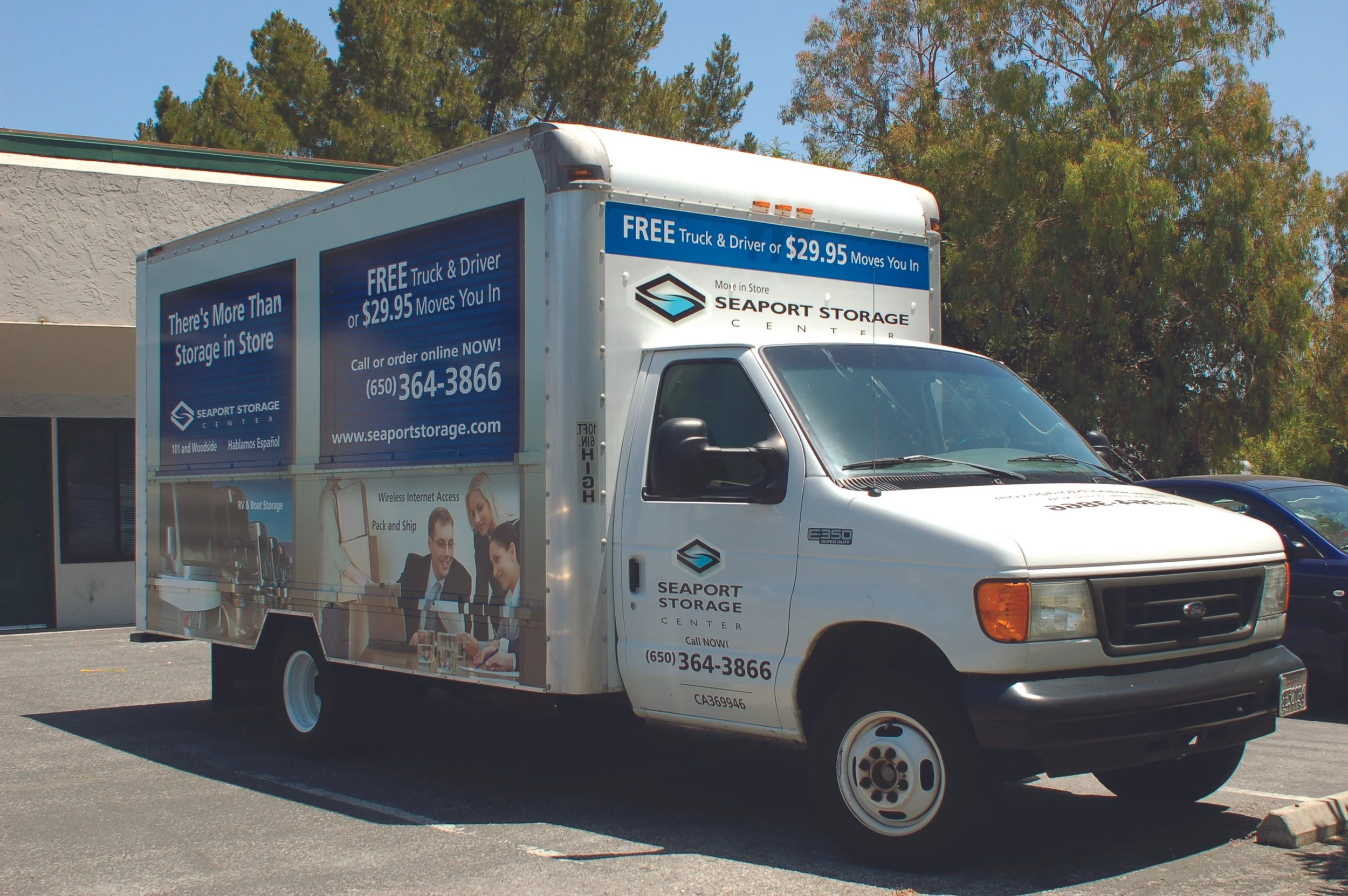 Utility truck featuring large-scale fleet graphics and side panel branding for corporate transportation and service operations.