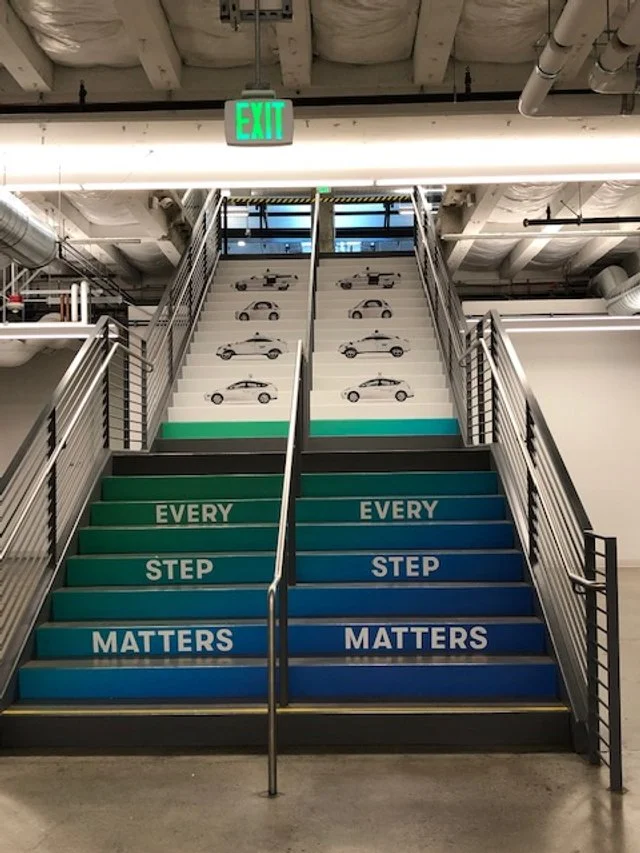Motivational stair graphics installed to encourage movement and enhance visibility in high-traffic building