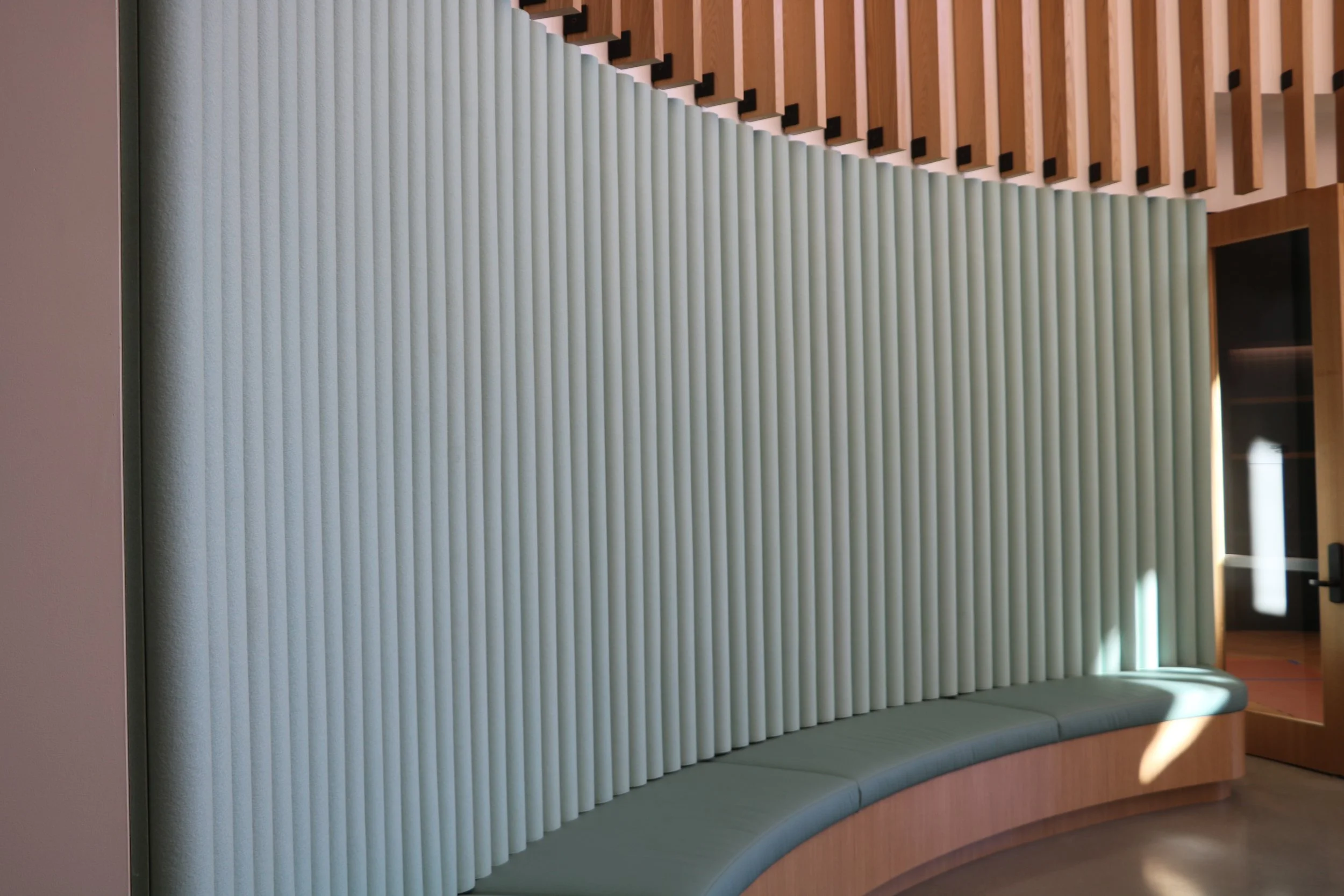 Curved acoustic wall panels installed in a commercial interior to improve sound control and enhance architectural design