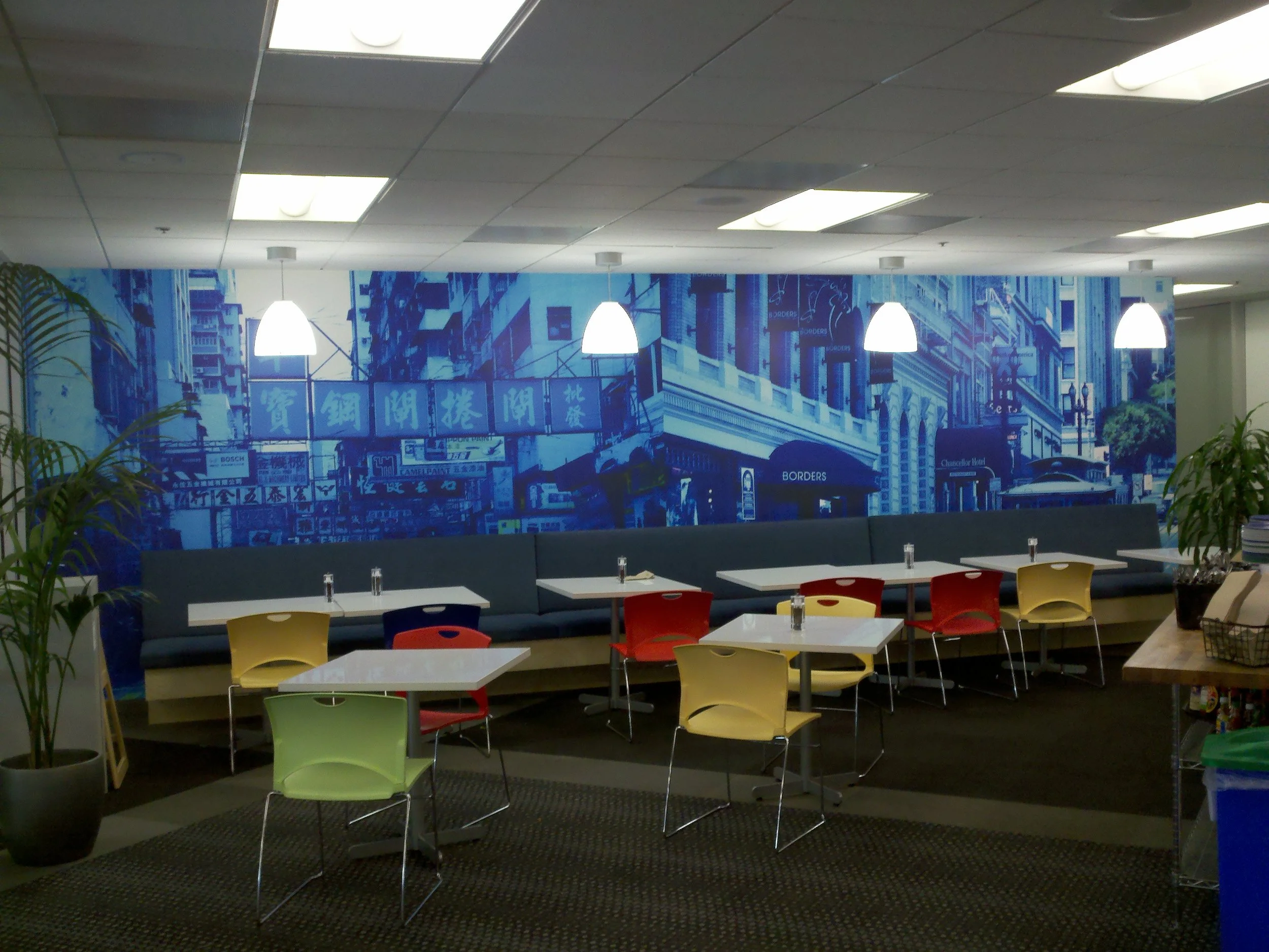 Custom city skyline wallcovering used to enhance a collaborative workspace with large-format graphics.