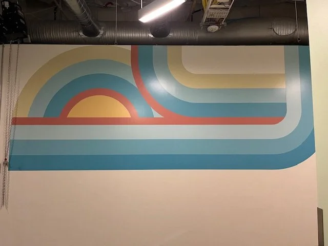 Close-up detail of geometric wall and stair environmental graphics installed in corporate workplace interior