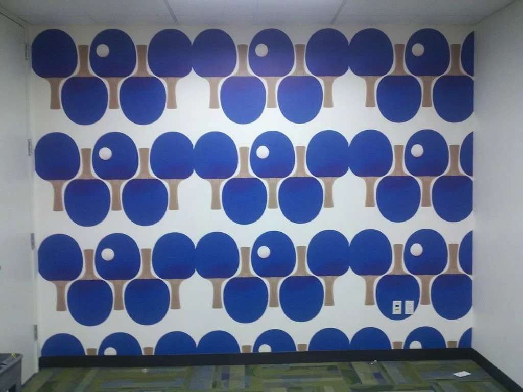 Bold geometric circle pattern wallcovering used as a decorative feature in a commercial interior.