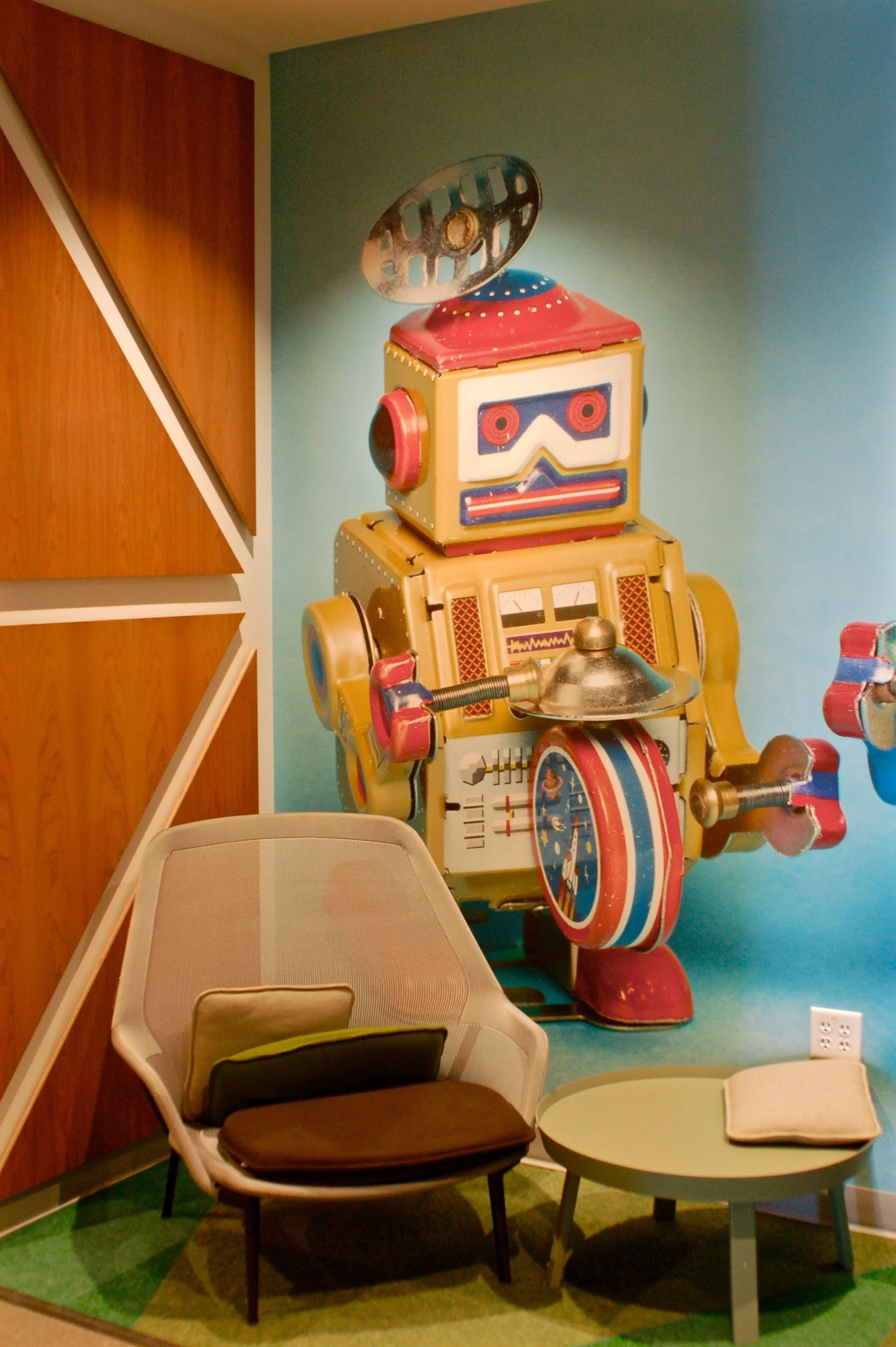 Creative branded wall graphics and dimensional feature elements installed to enhance a corporate interior.