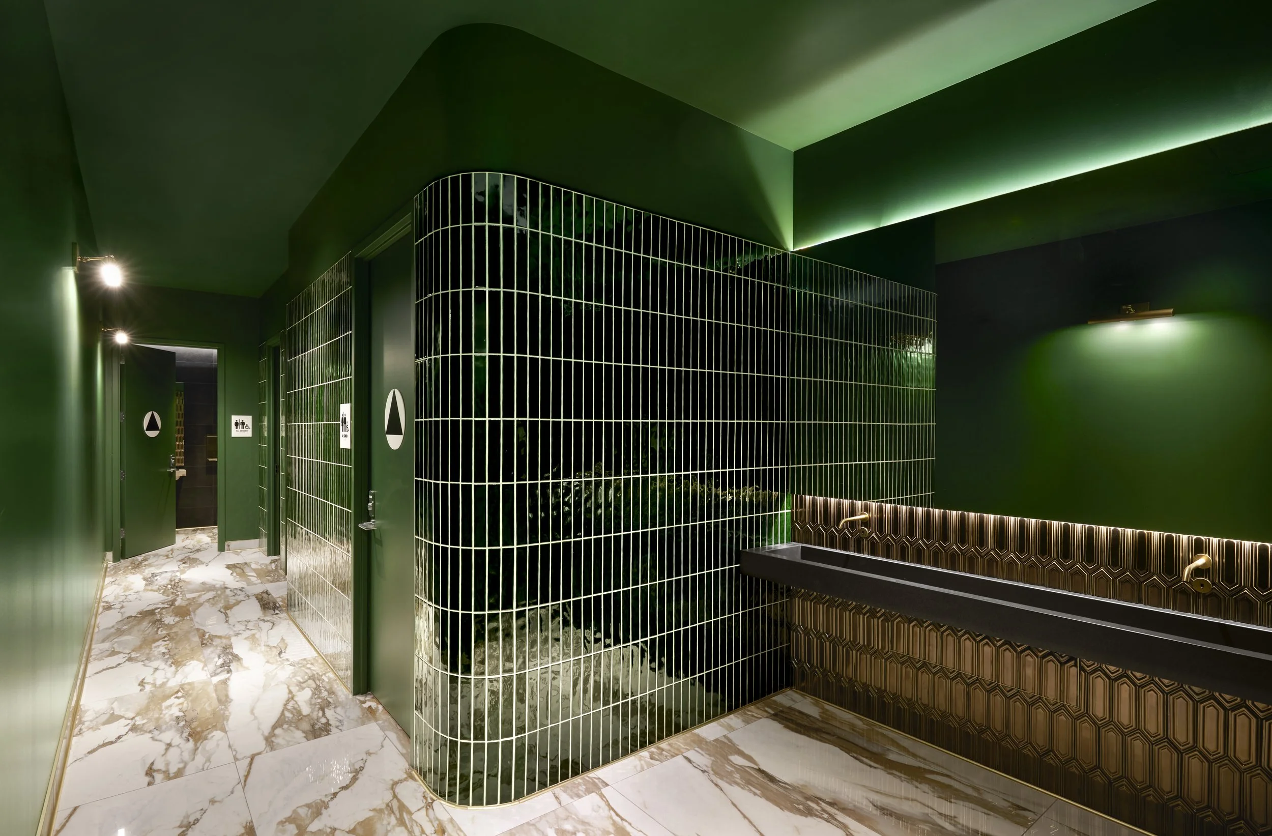 ADA-compliant restroom signage installed in commercial interior, featuring accessible wayfinding and tactile signage for public restrooms