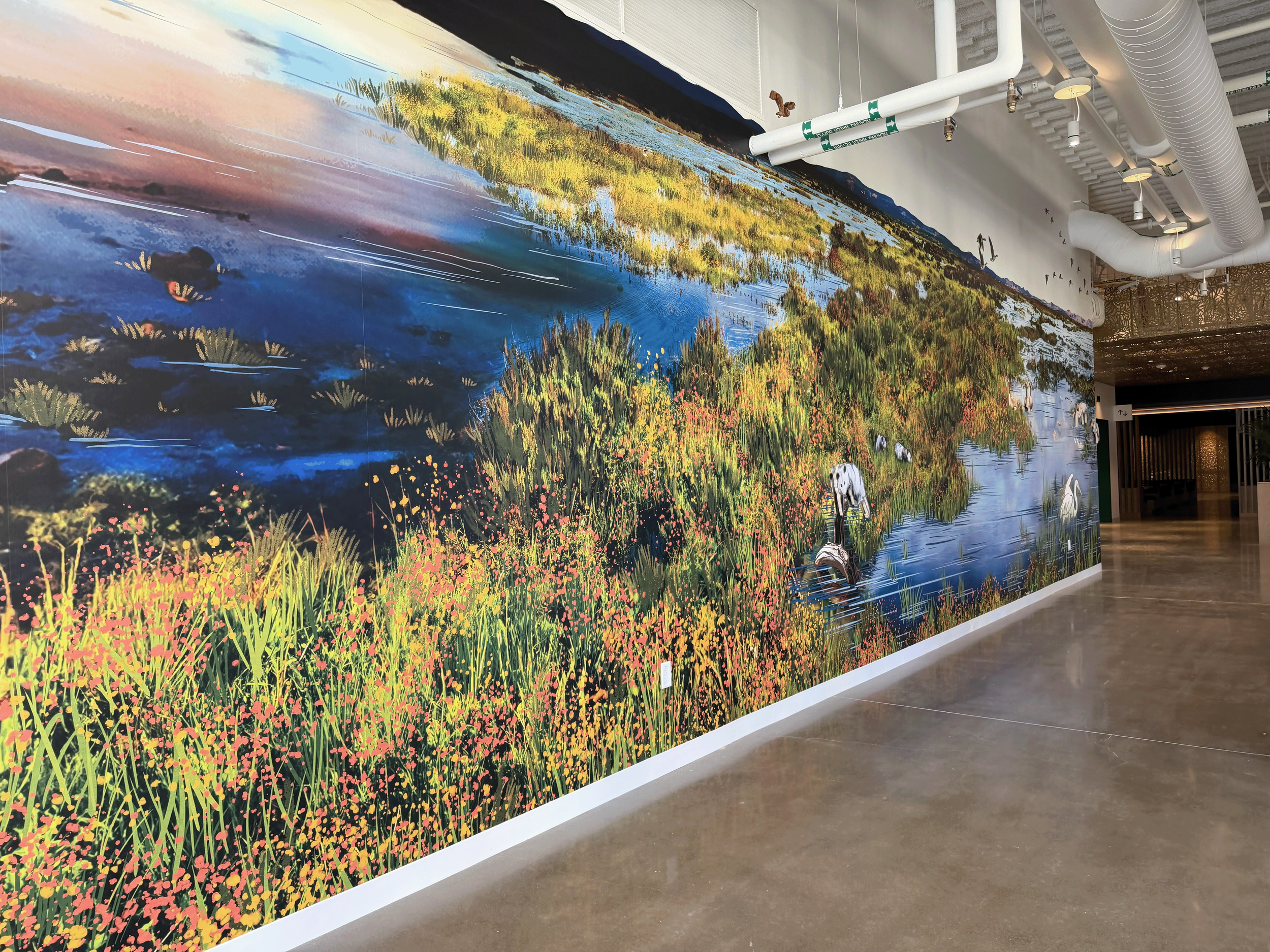 Large-format custom wallcovering mural for commercial interior hallway featuring nature imagery and environmental branding