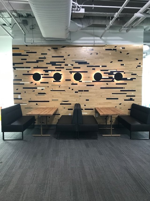 Acoustic wood slat wall panels in collaborative workspace for improved sound control and design