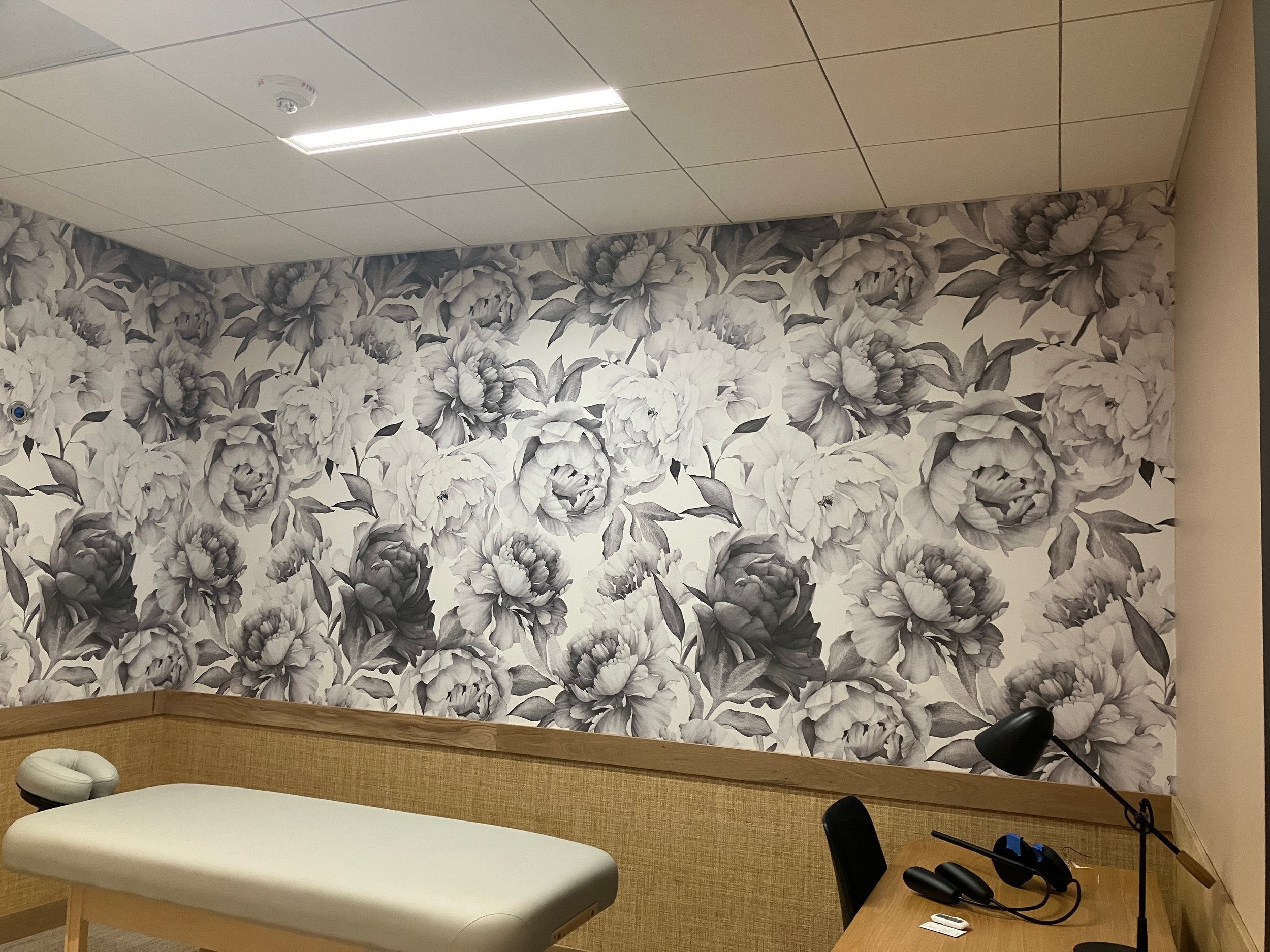 Black-and-white patterned wallcovering adding texture and visual interest to a modern workspace.